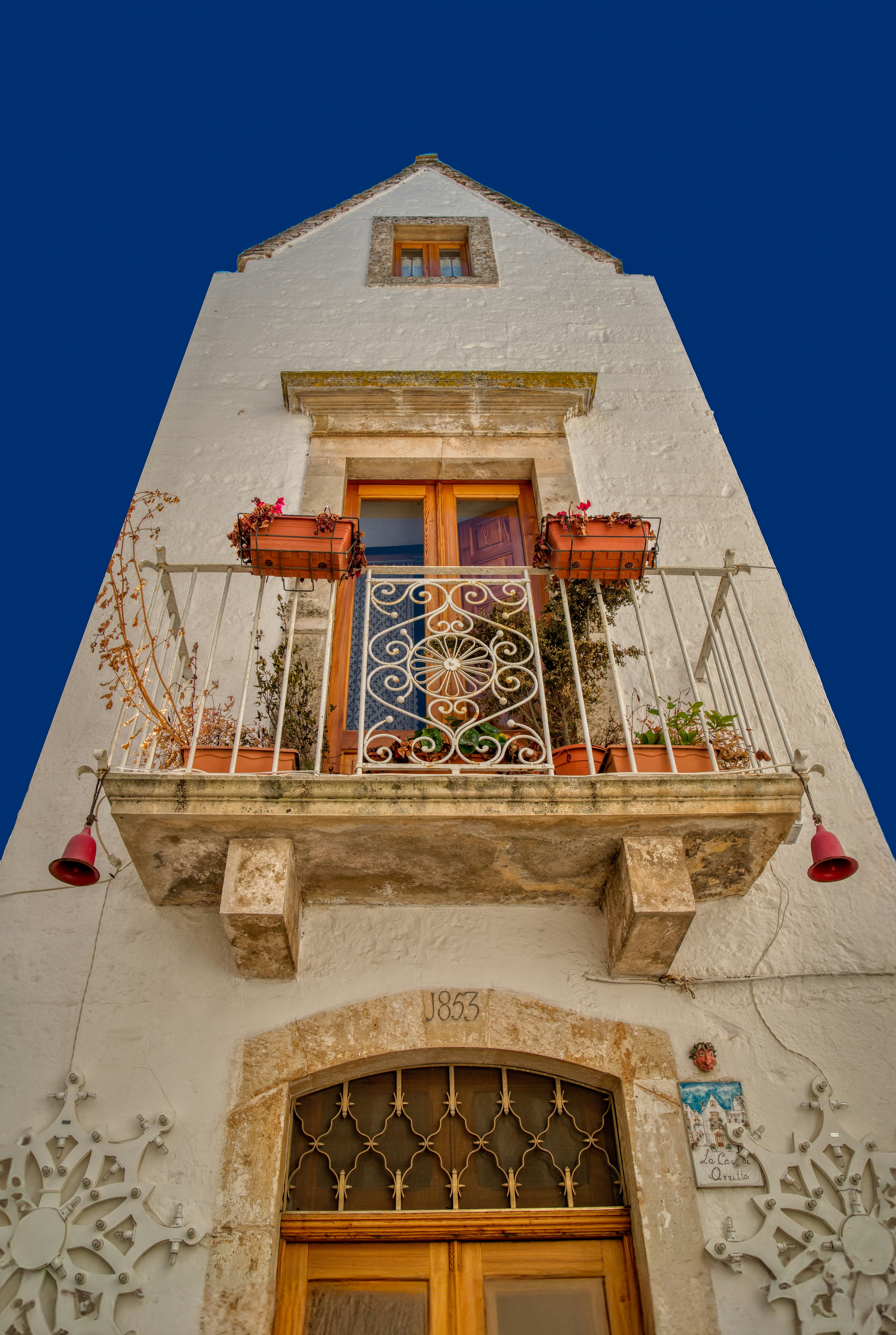 a tall building with a balcony and a door