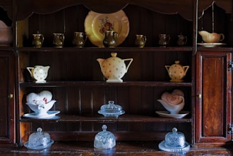 a shelf filled with lots of different types of vases