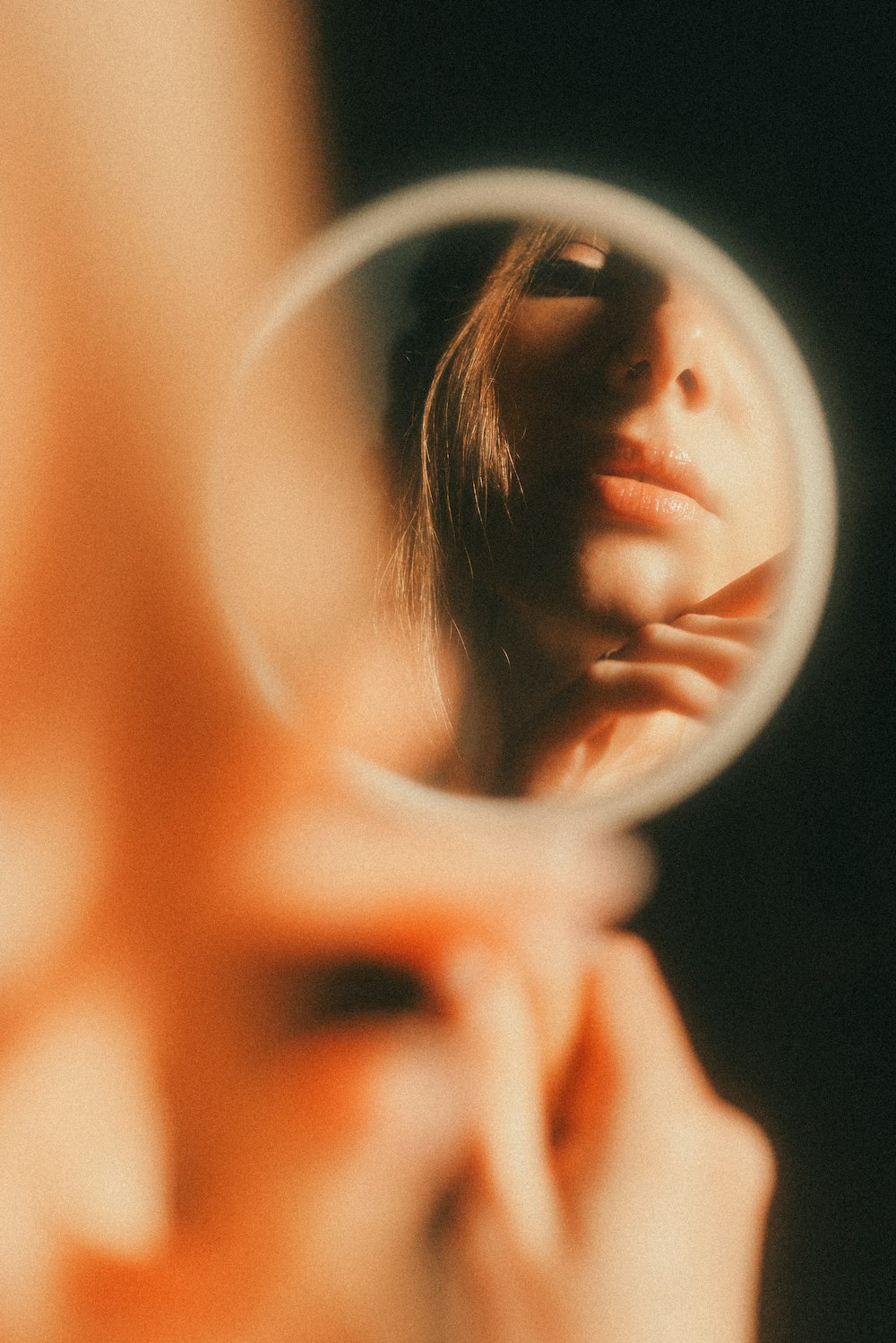 a woman looking through a magnifying glass