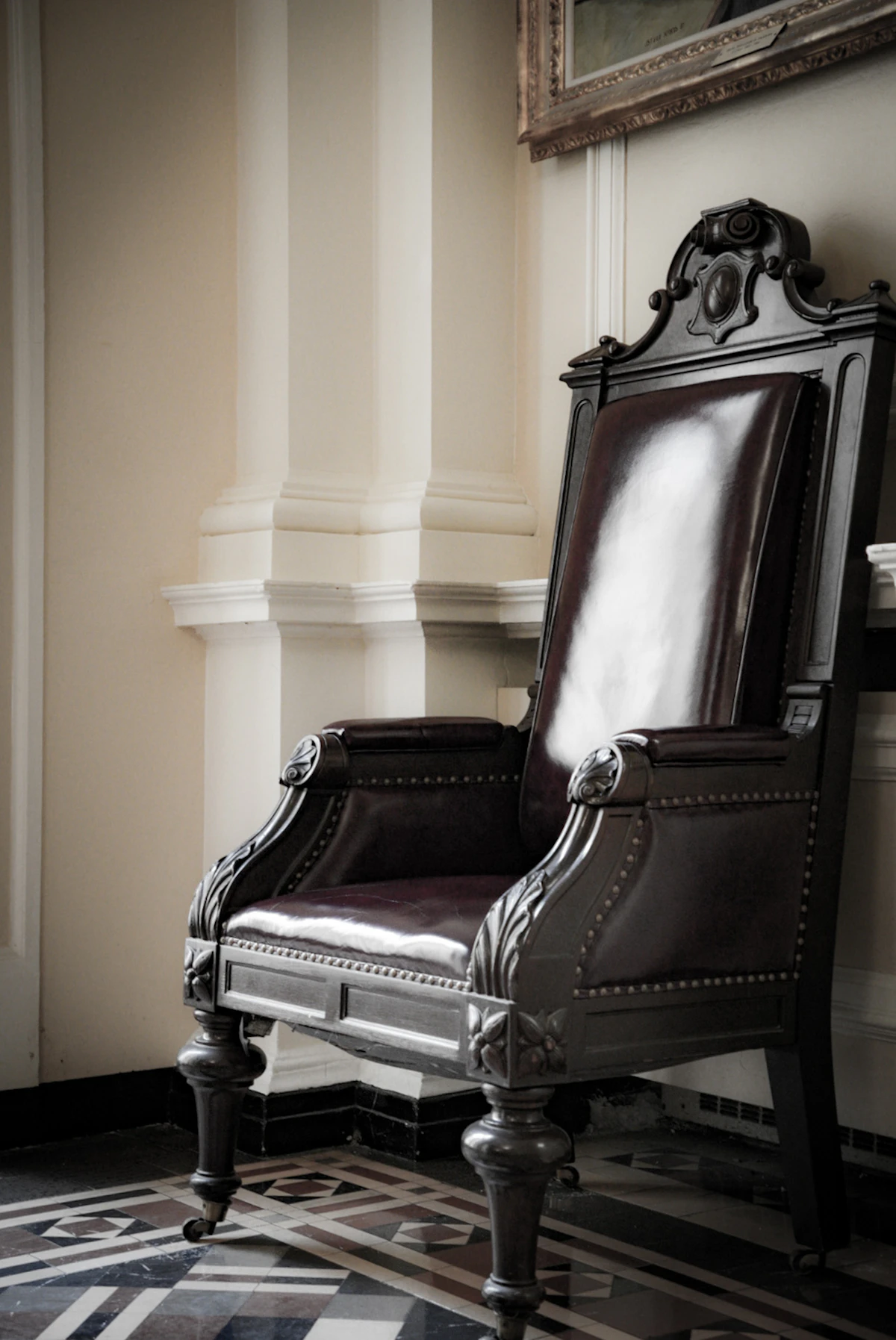Executive leather chair in a darkened boardroom.