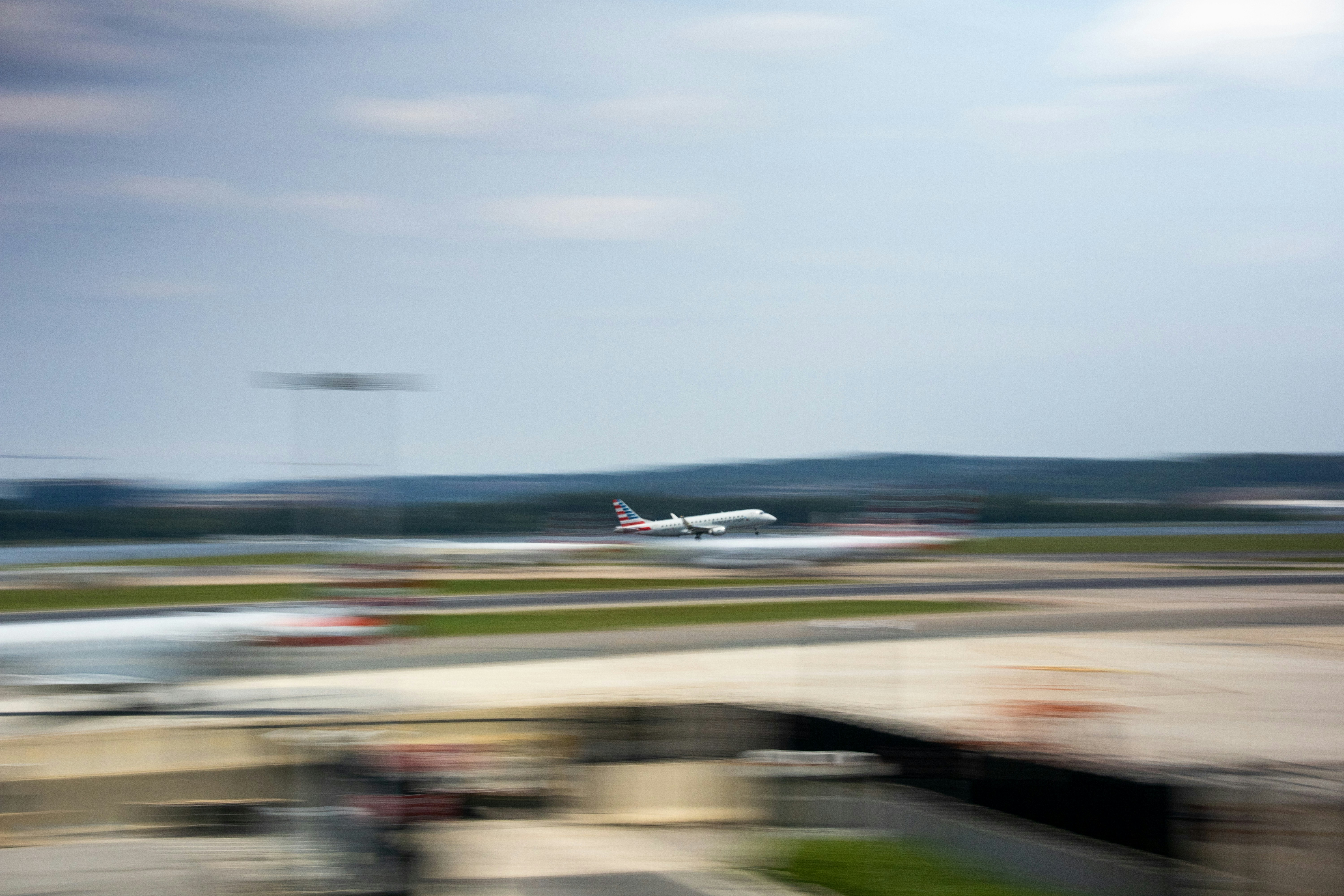 a blurry photo of a plane taking off from an airport