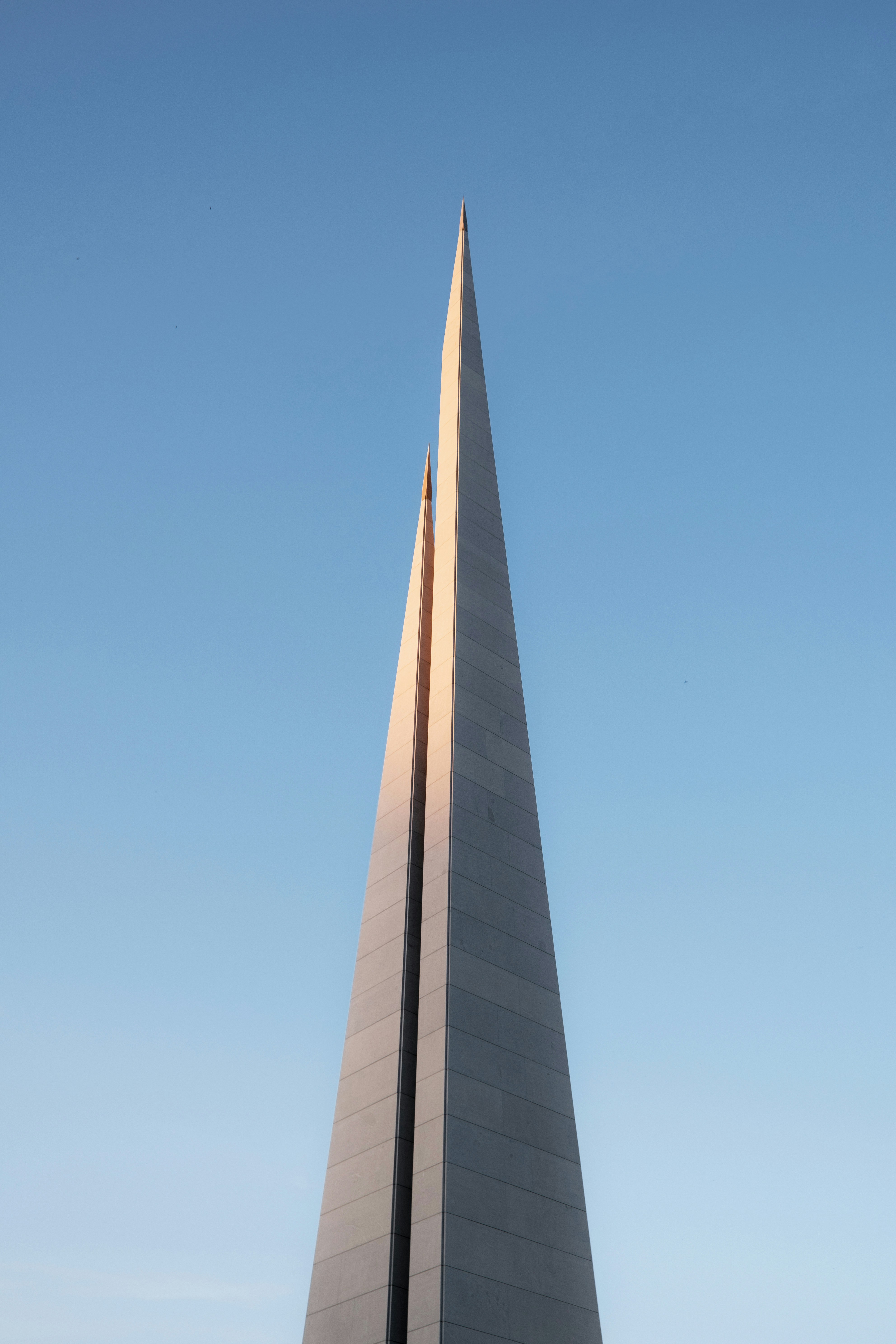 a very tall monument with a clock on it's side