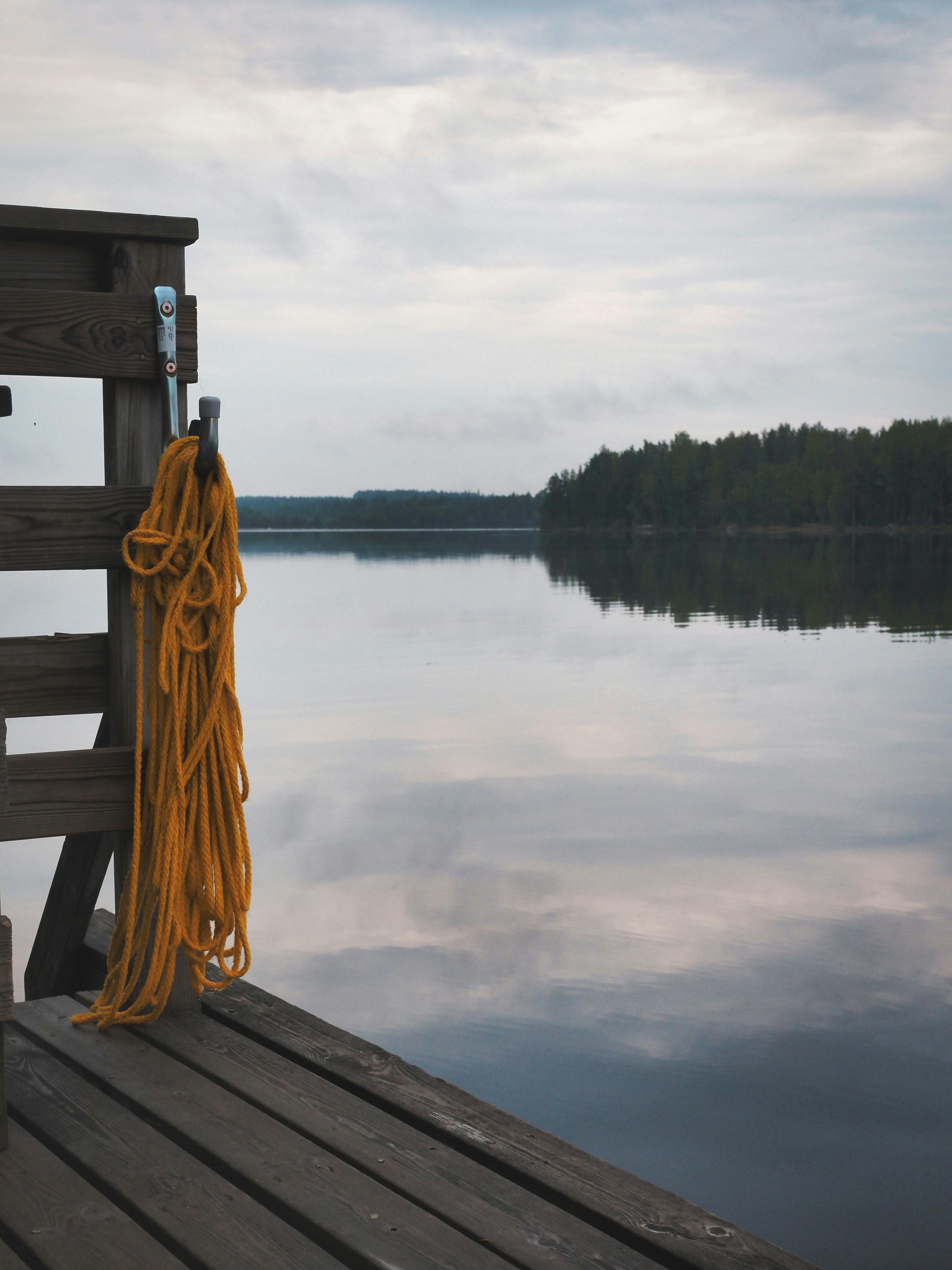a yellow rope is tied to a wooden dock