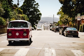 a red and white van driving down a street