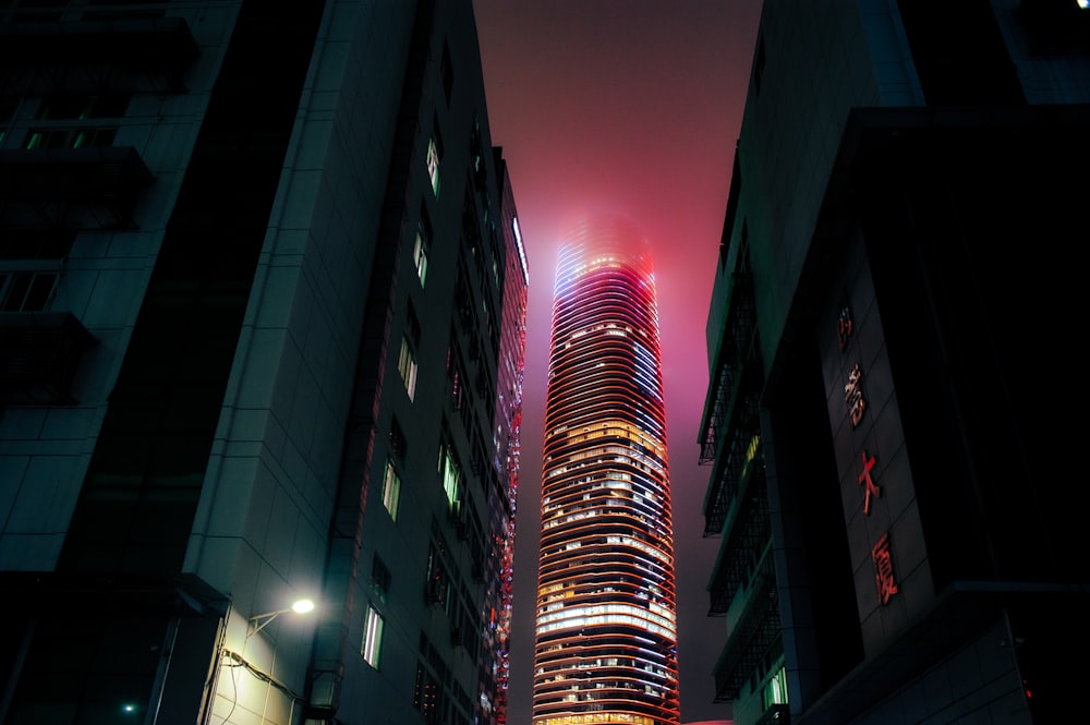 a very tall building in a city at night