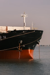 a large boat in the water near a dock