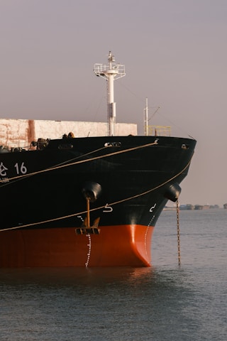 a large boat in the water near a dock