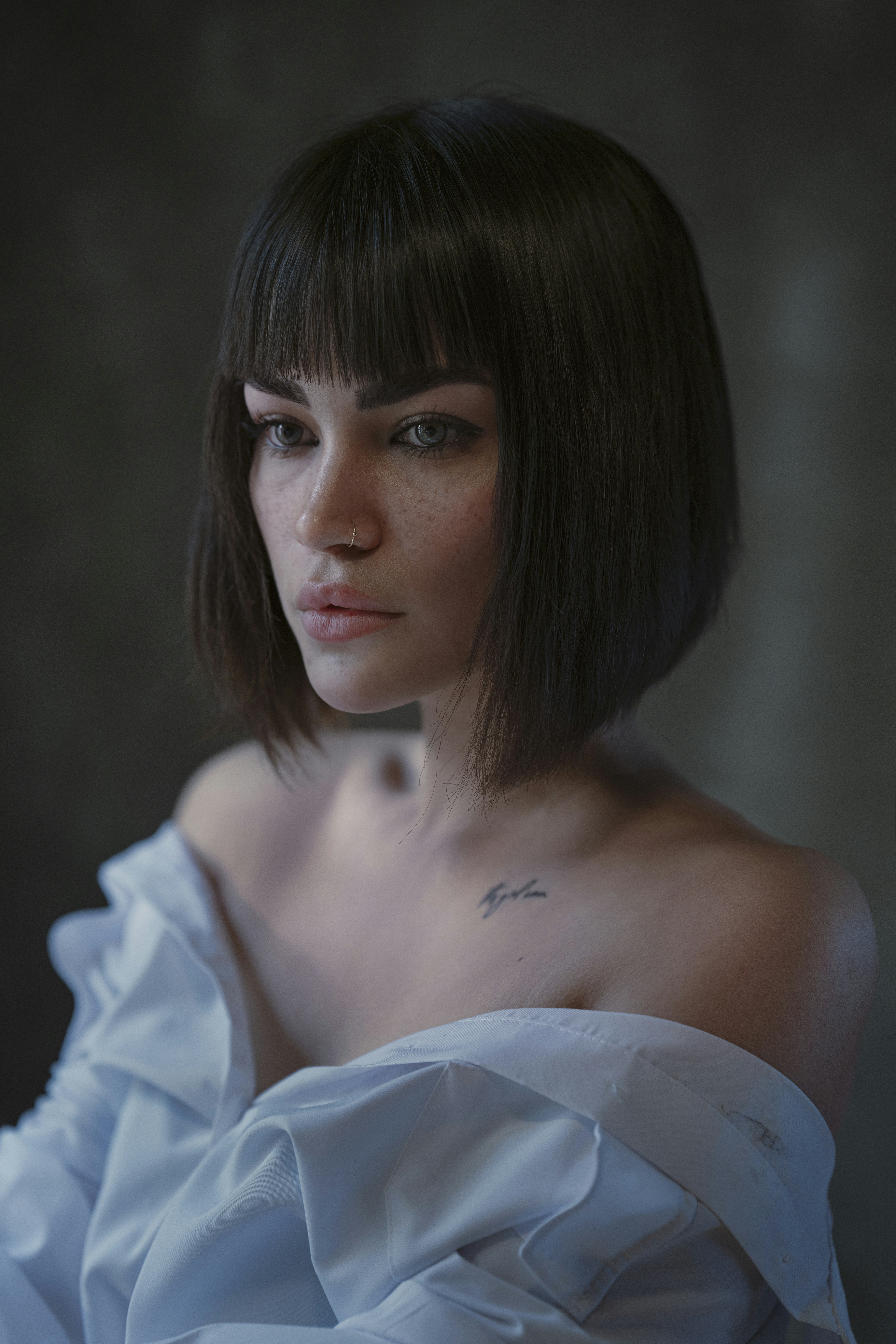 a woman with short hair wearing a white dress