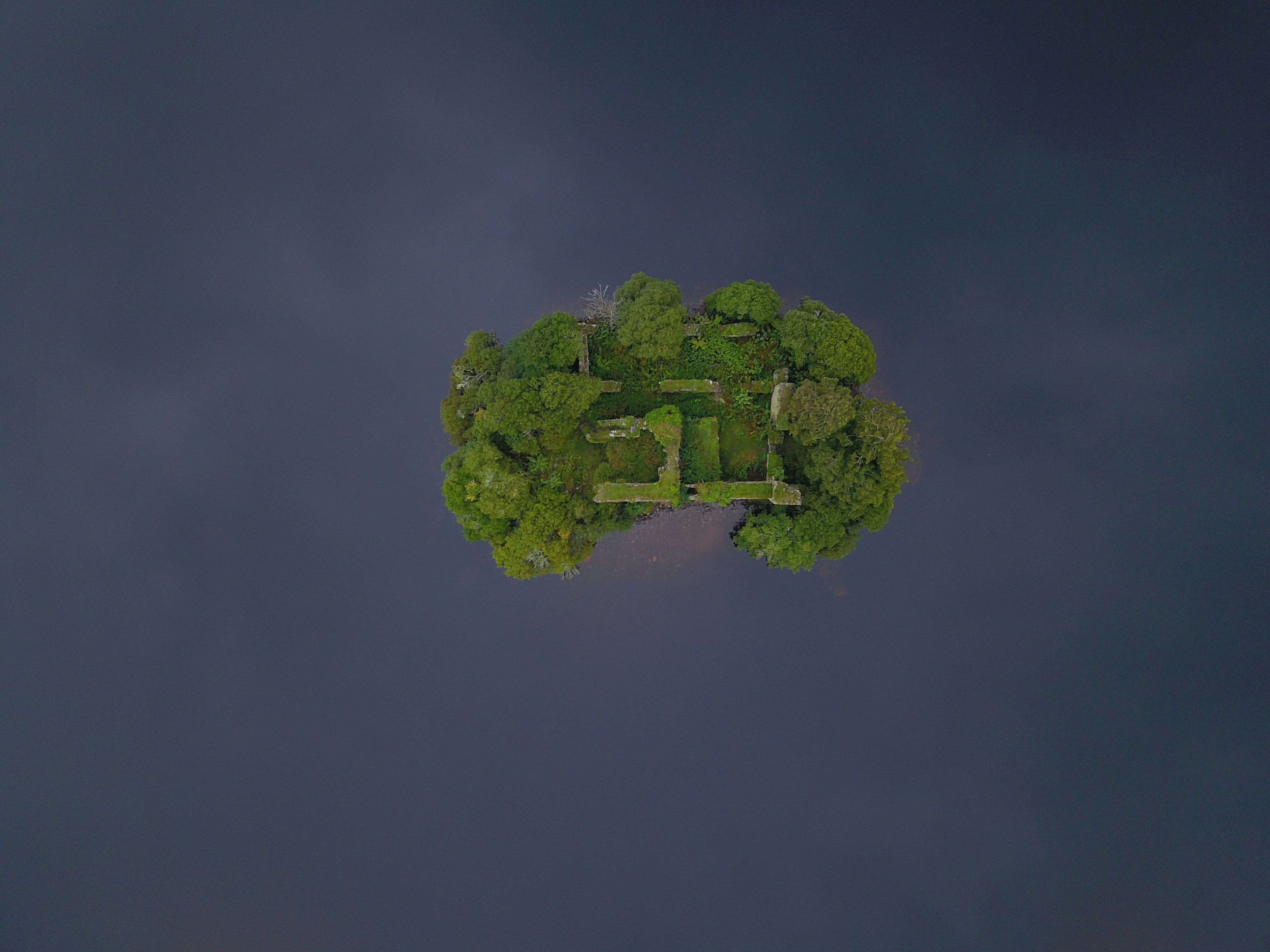 Loch an Eilein Castle, Loch an Eilein, Cairngorms National Park. The drone was able to capture this direct over head shot of the castle with the green contrasting with the dark blue water of the loch.