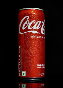 a can of coca cola on a black background