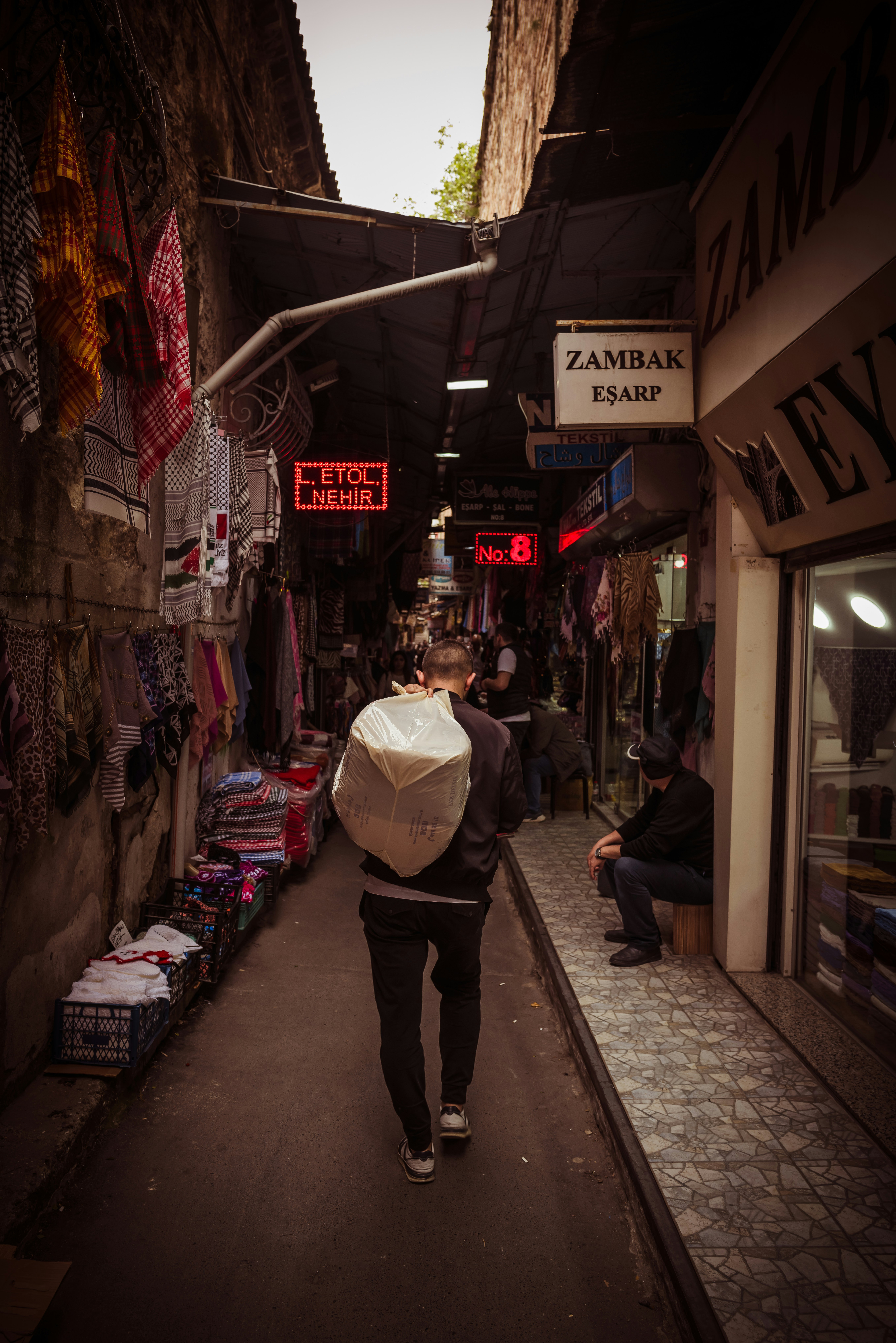 a person walking down a street holding an umbrella