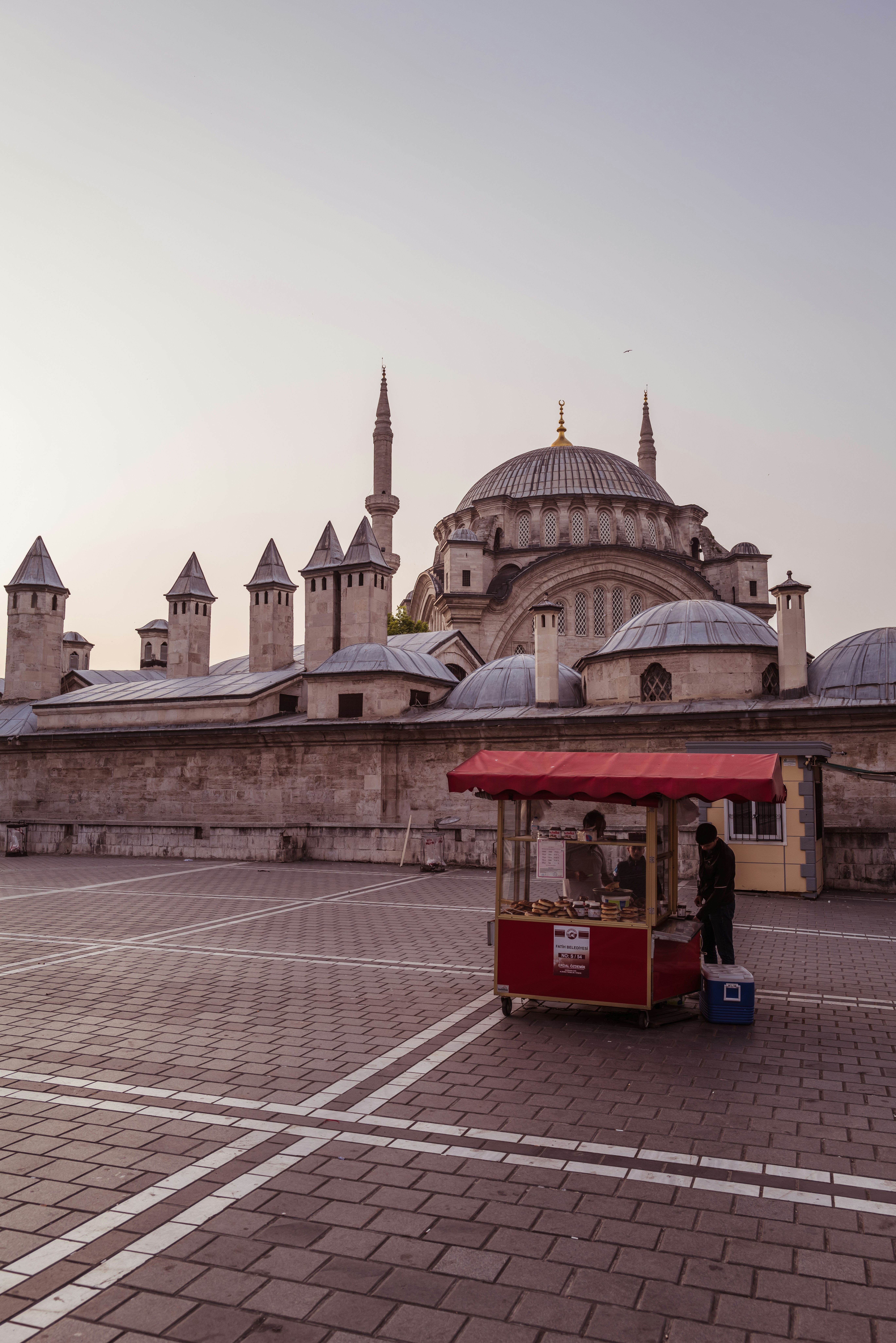 a red and yellow cart sitting in front of a building