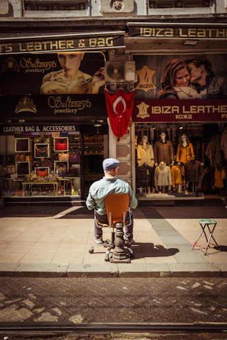 a man sitting on a chair in front of a store