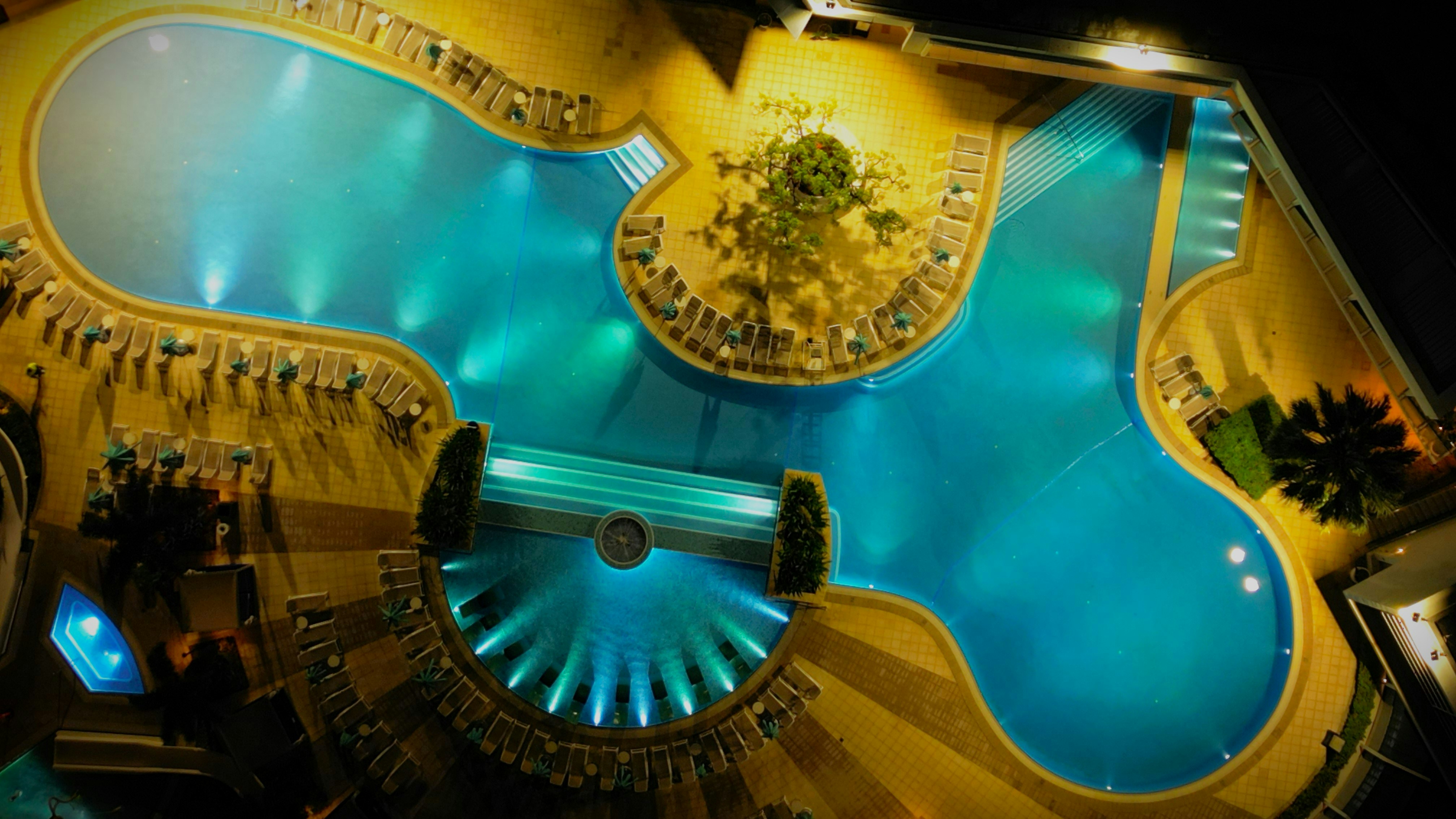 an overhead view of a swimming pool at night
