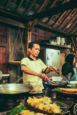 a man standing in front of a table filled with food