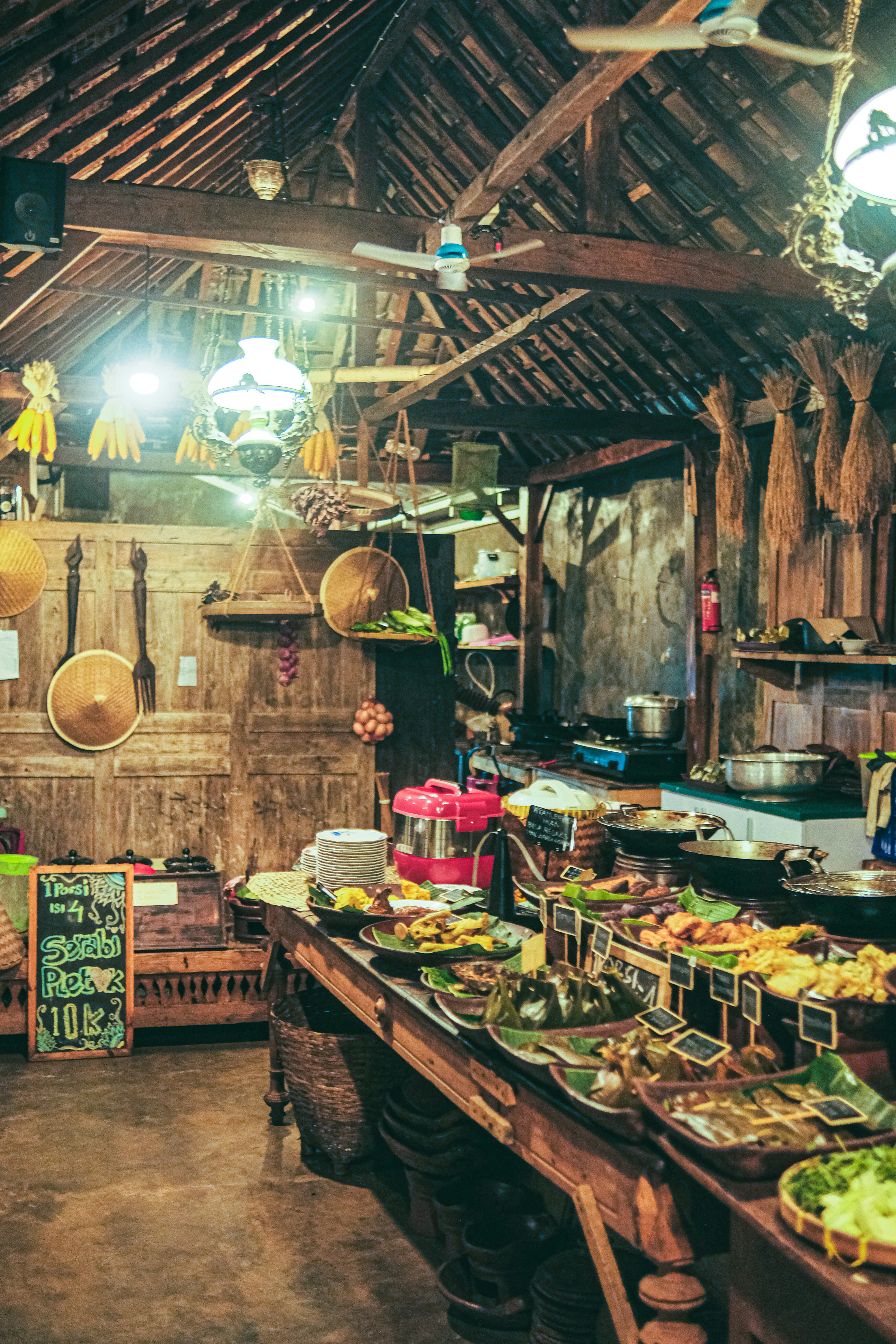 Rustic French market with seasonal truffles and foie gras, warm indoor market lighting, rich dark tones