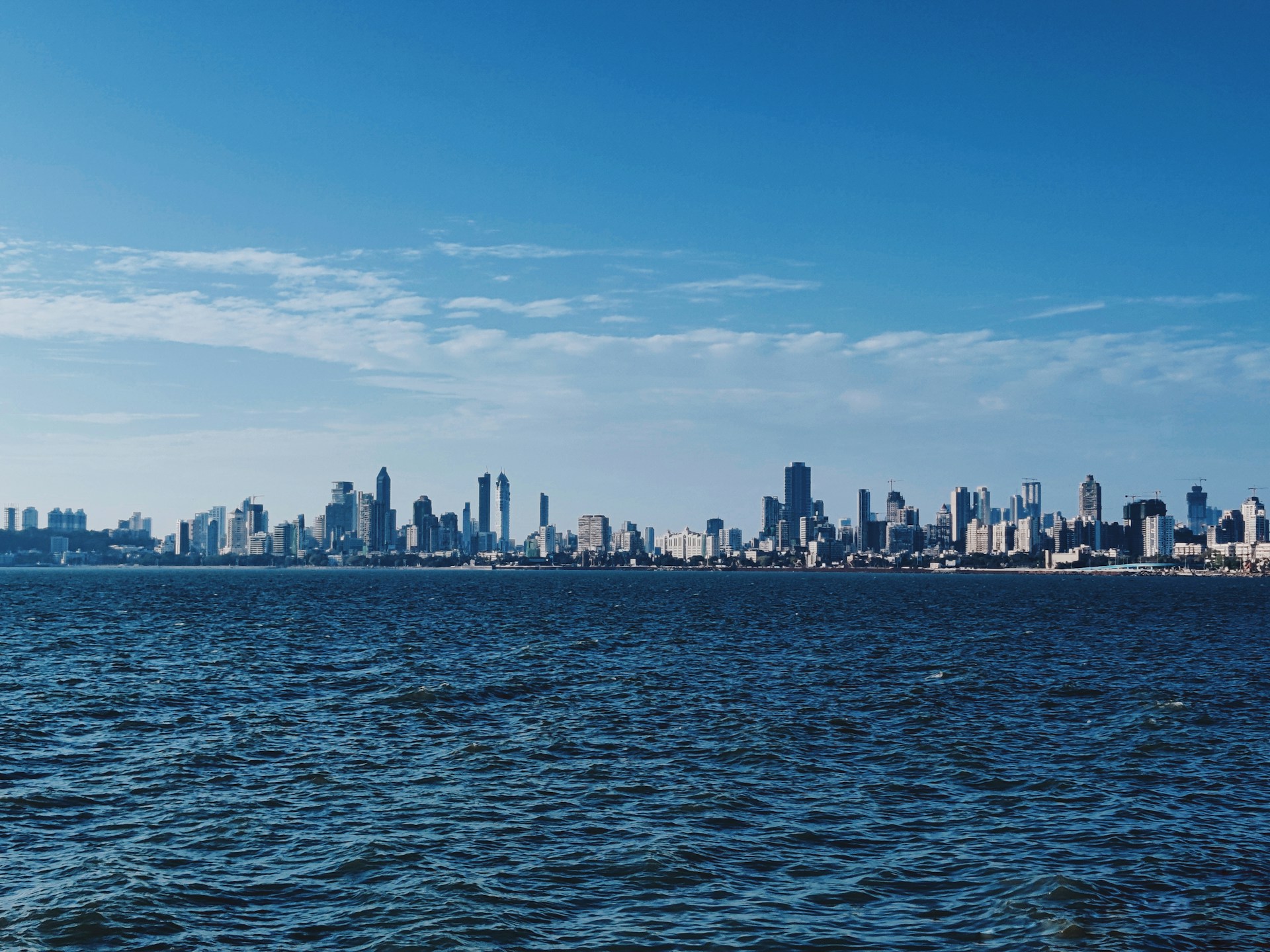 a large body of water with a city in the background