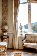 a living room filled with furniture and a large window