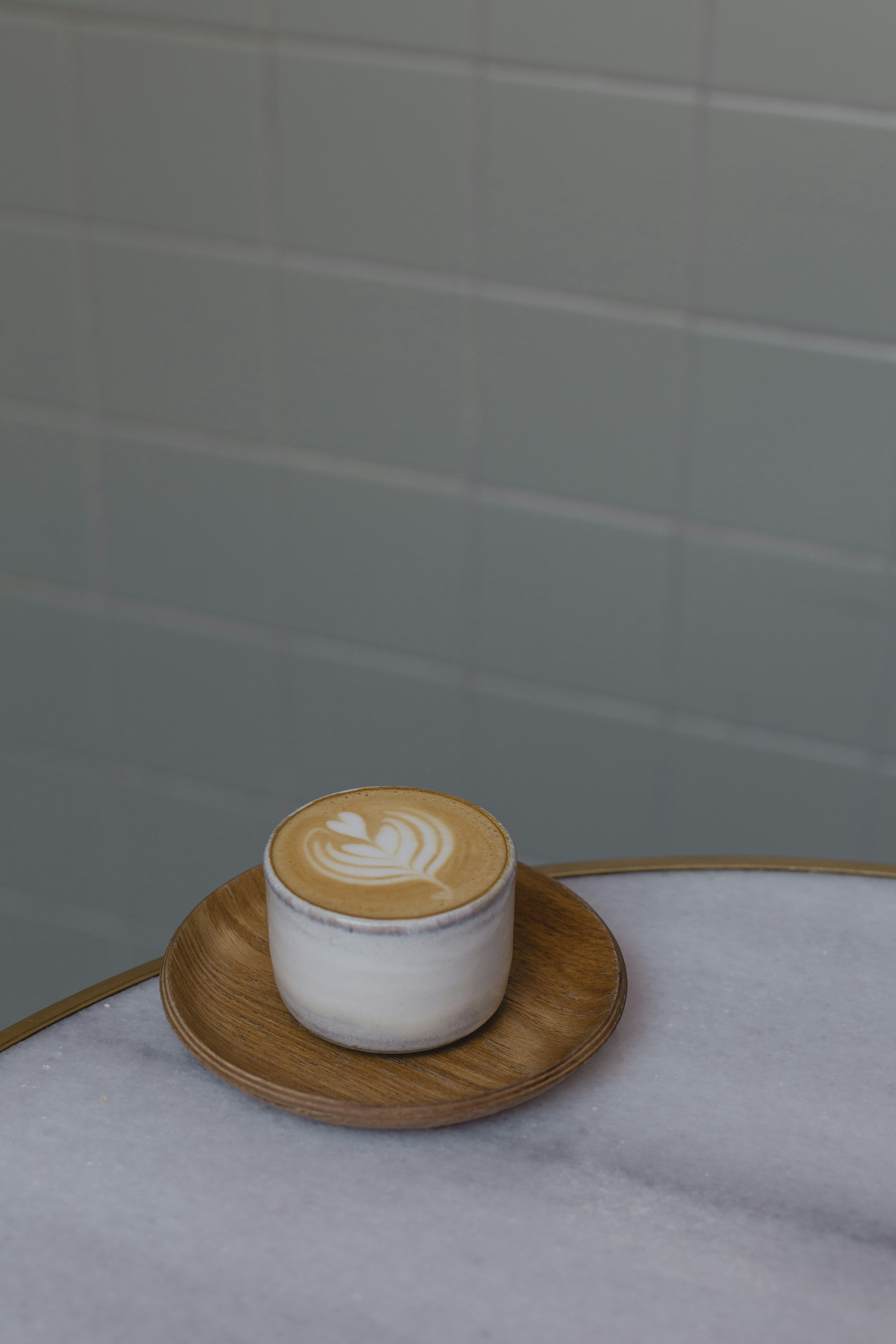 a cup of coffee sitting on top of a white table