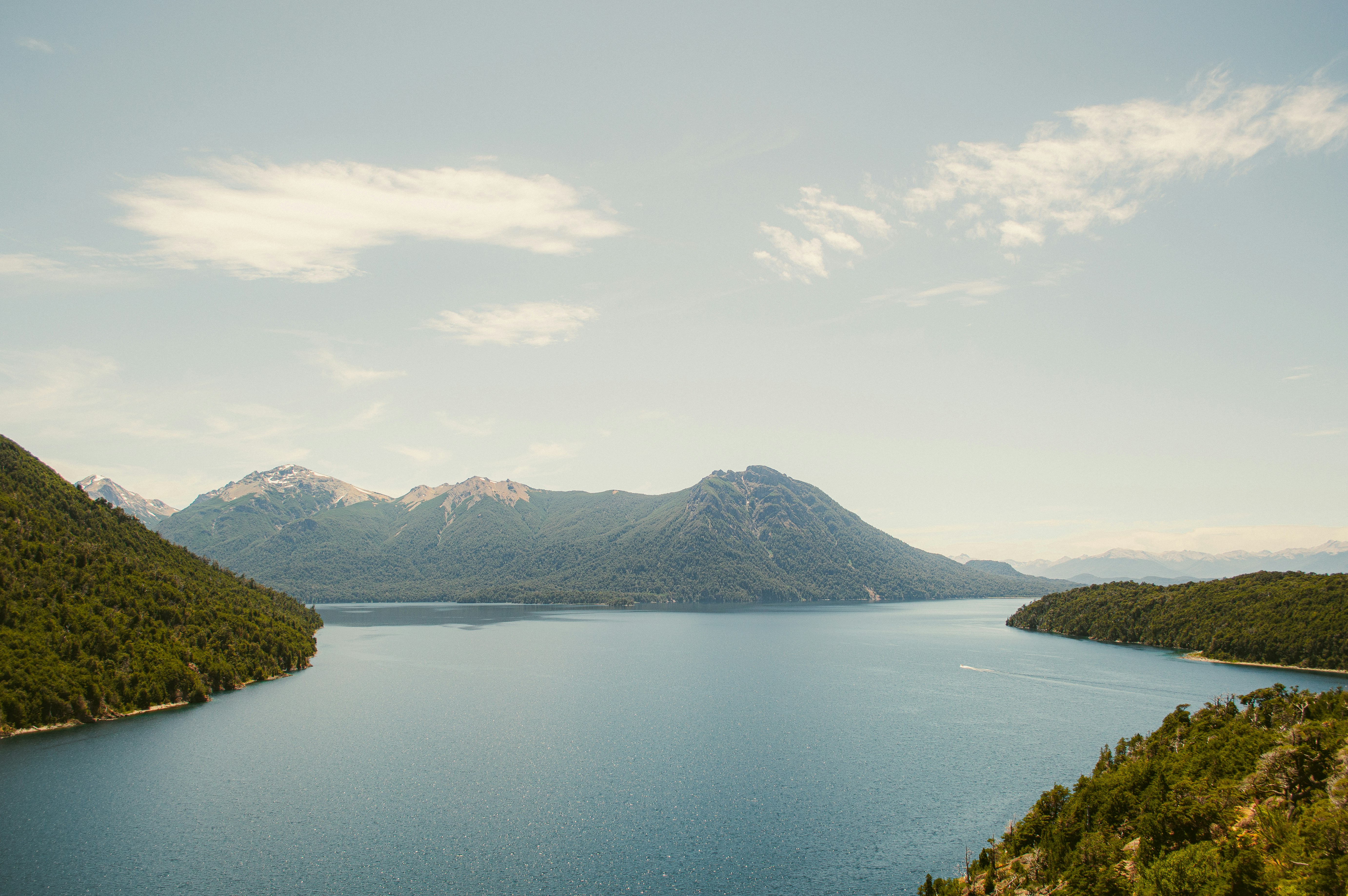 a large body of water surrounded by mountains, 