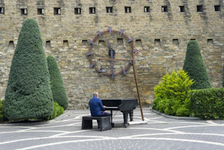 a man sitting on a bench playing a piano