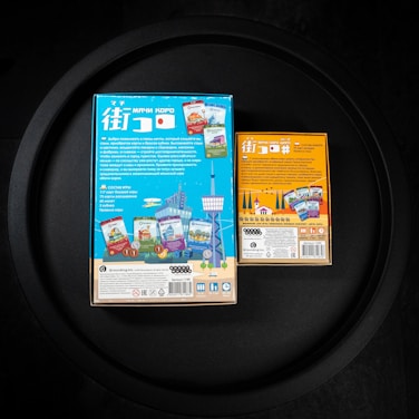two boxes of children's toys sitting on a table