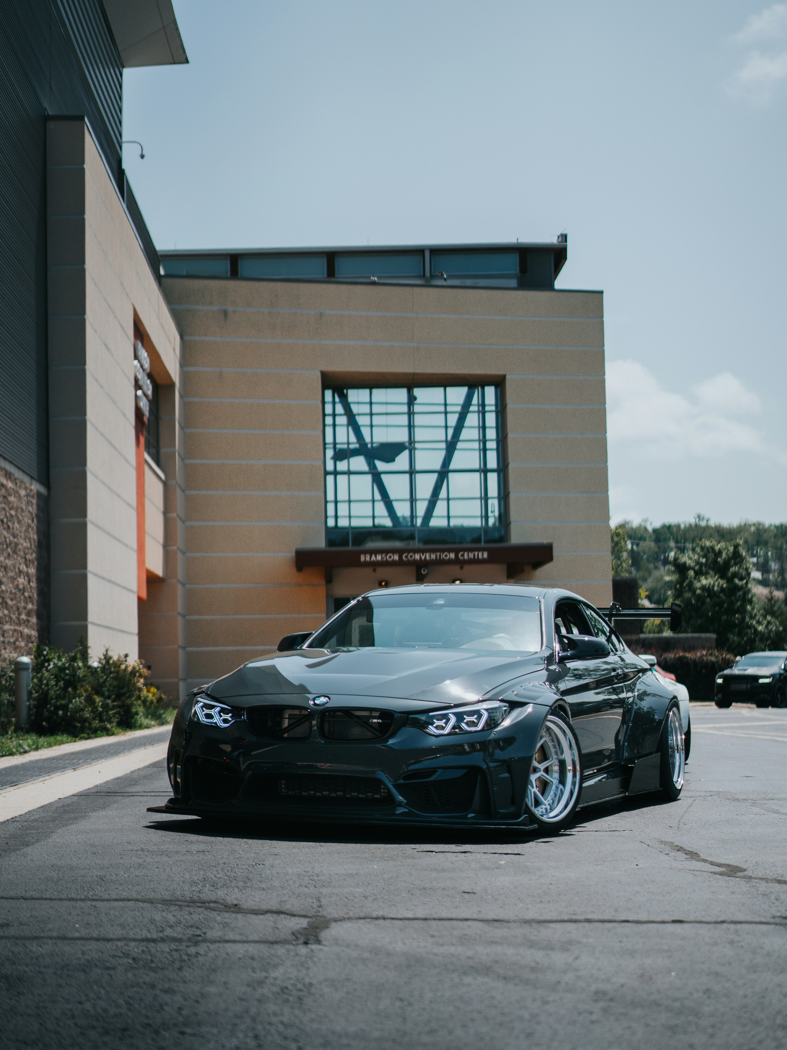 a black car parked in front of a building