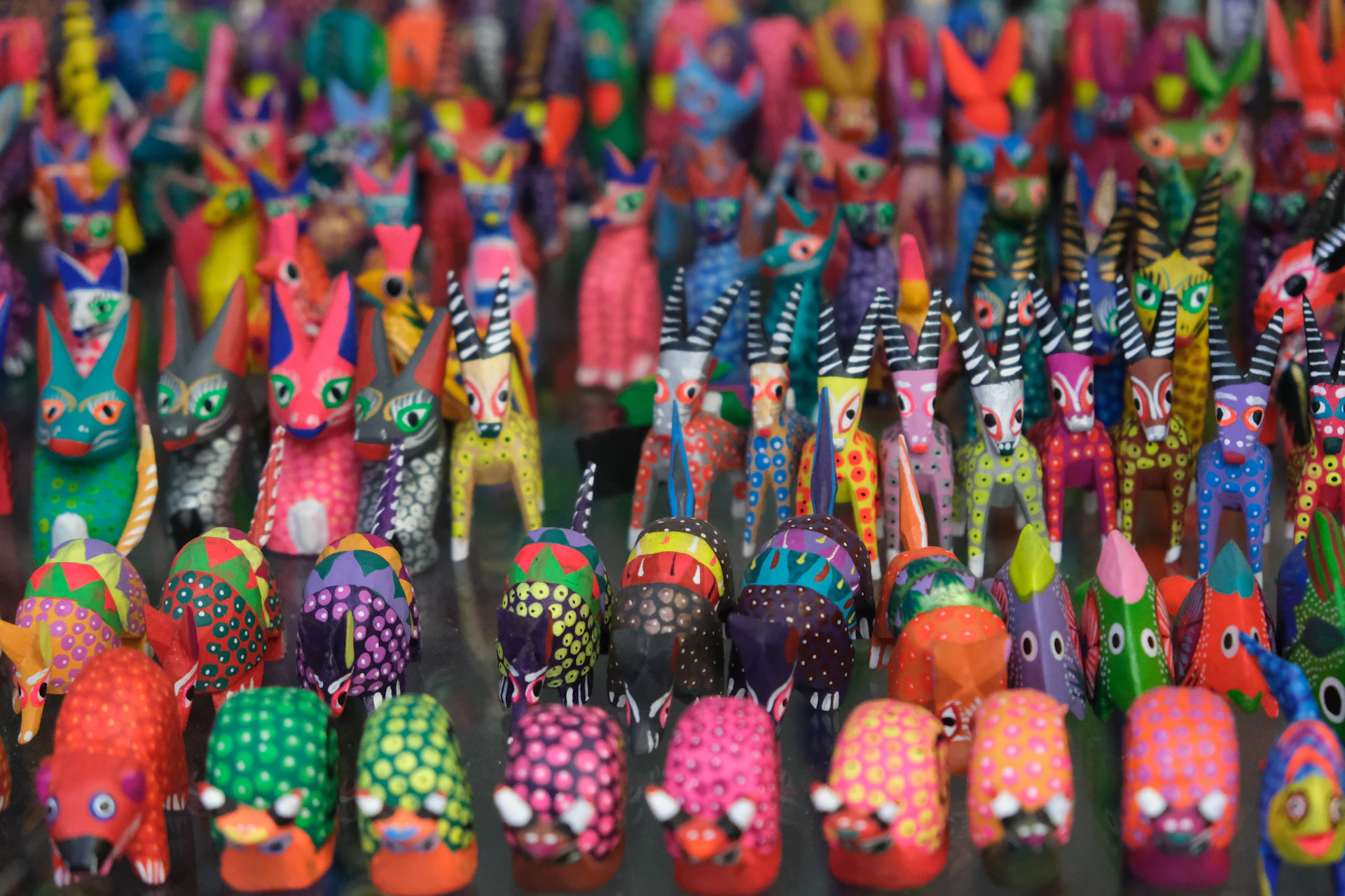 a large group of brightly colored toy animals