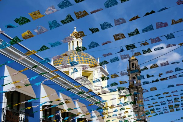 A building with many flags flying in the air — Puebla, Mexico