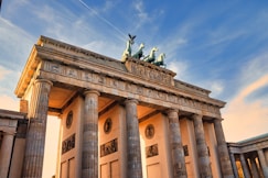 a very tall building with some statues on top of it