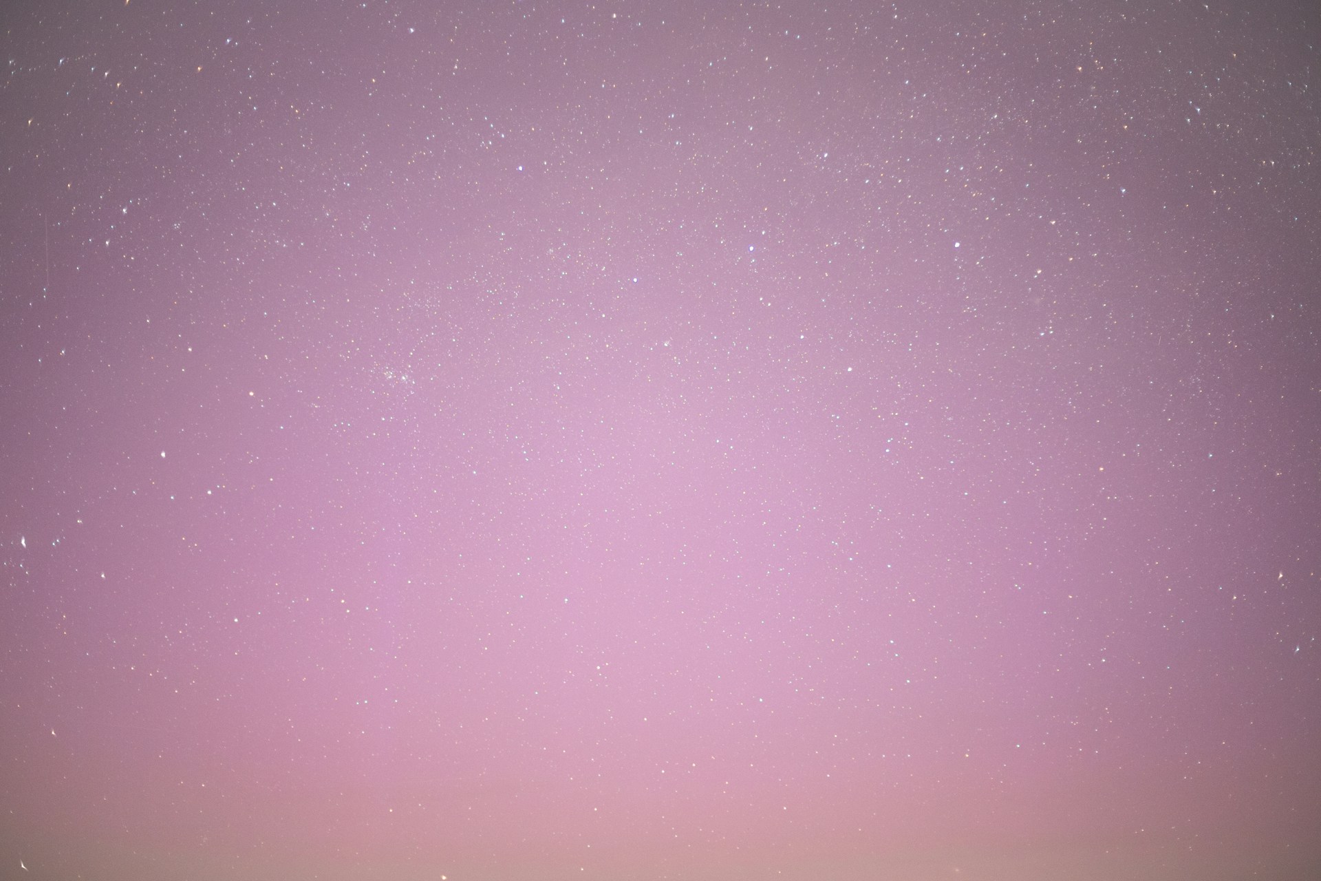 a purple sky with a few stars in it