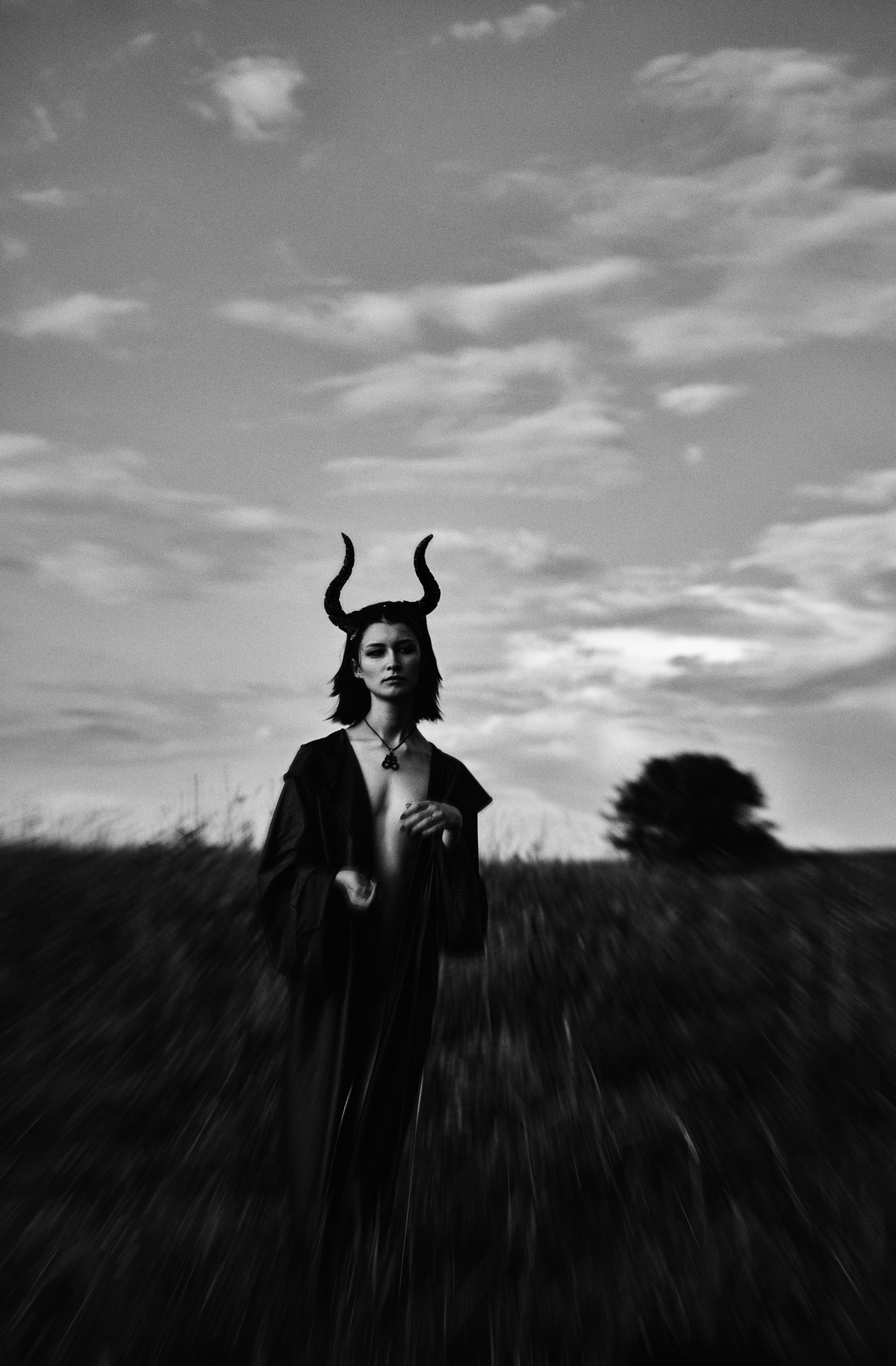 a woman wearing a horned head dress in a field