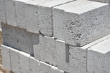 a stack of cinder blocks sitting on top of a sidewalk