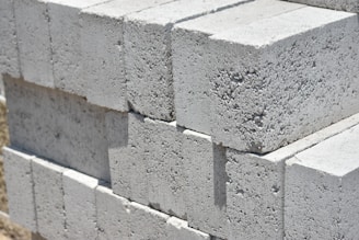 a stack of cinder blocks sitting on top of a sidewalk