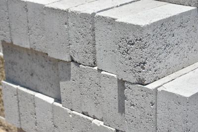 a stack of cinder blocks sitting on top of a sidewalk