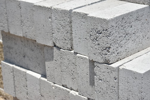 a stack of cinder blocks sitting on top of a sidewalk
