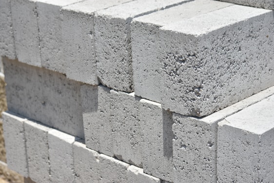 a stack of cinder blocks sitting on top of a sidewalk