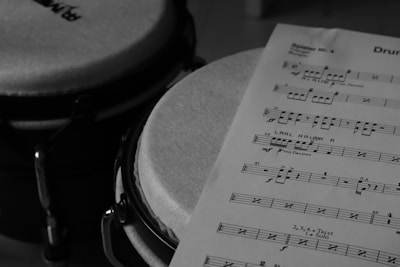 a sheet of music sitting on top of a drum