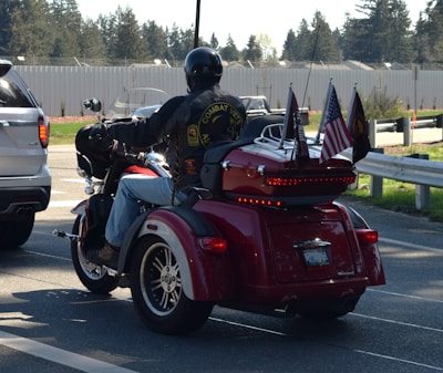 a man riding a motorcycle with a flag on the back of it