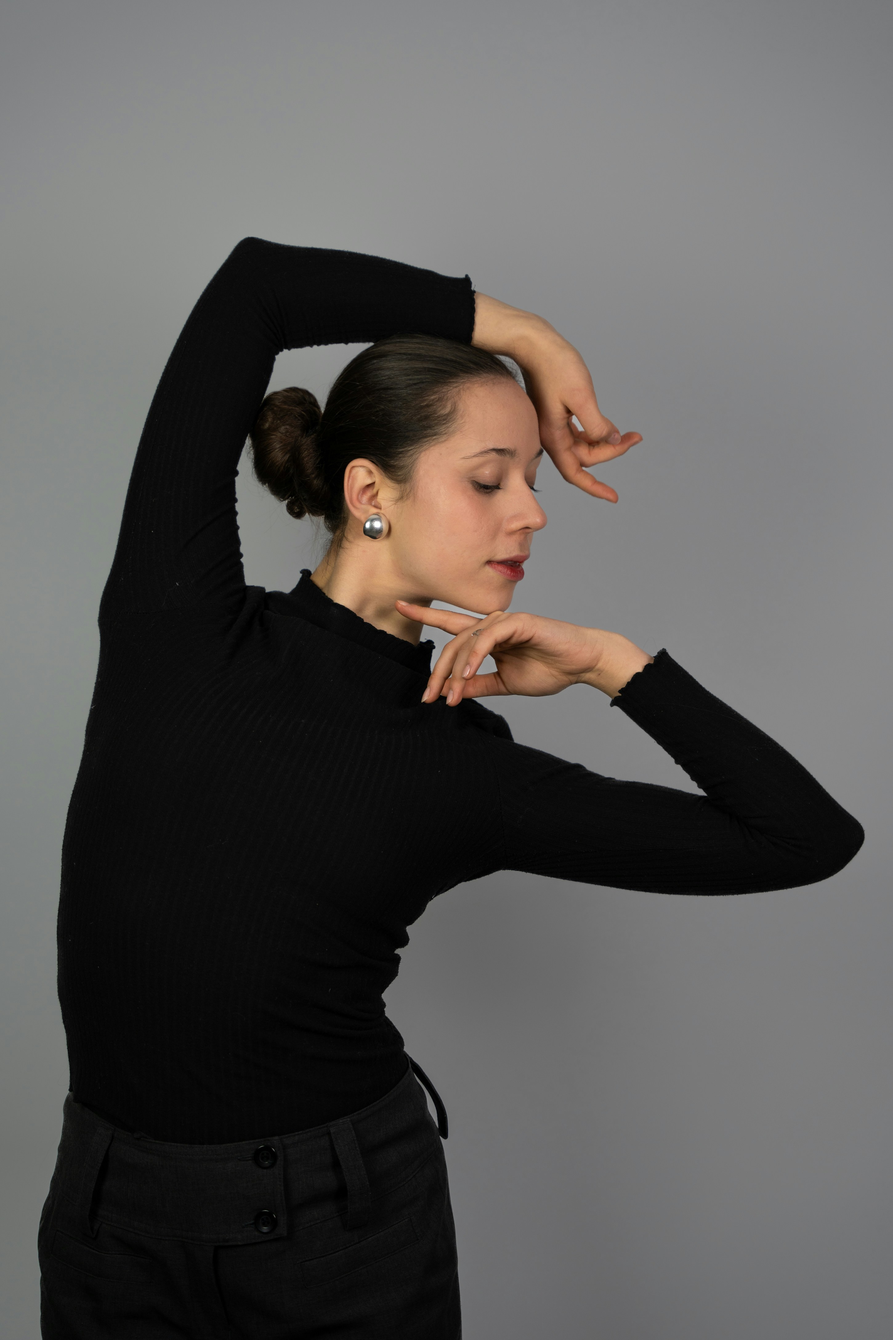 a woman in a black top is posing for a picture
