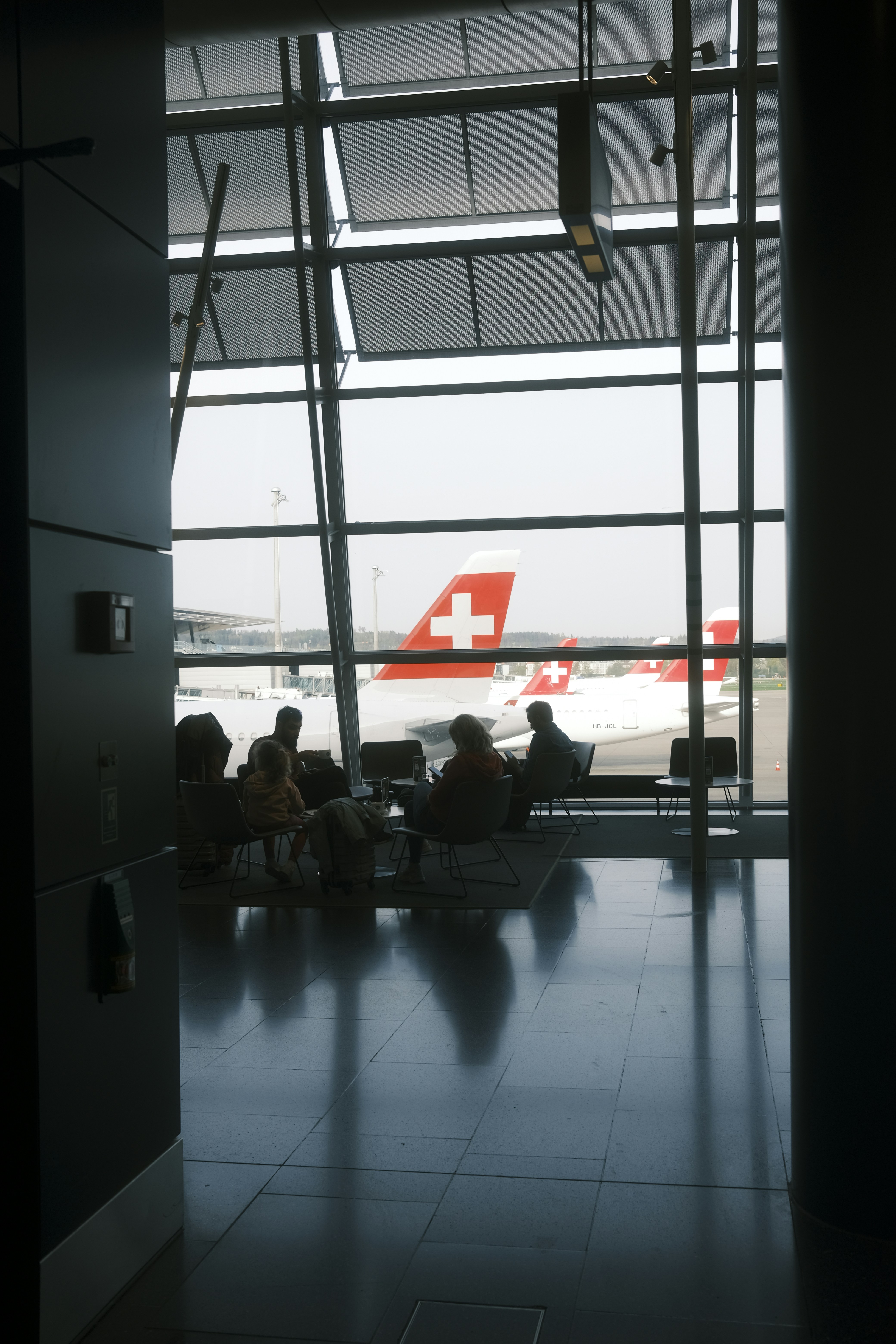 a group of people sitting in chairs in front of a window
