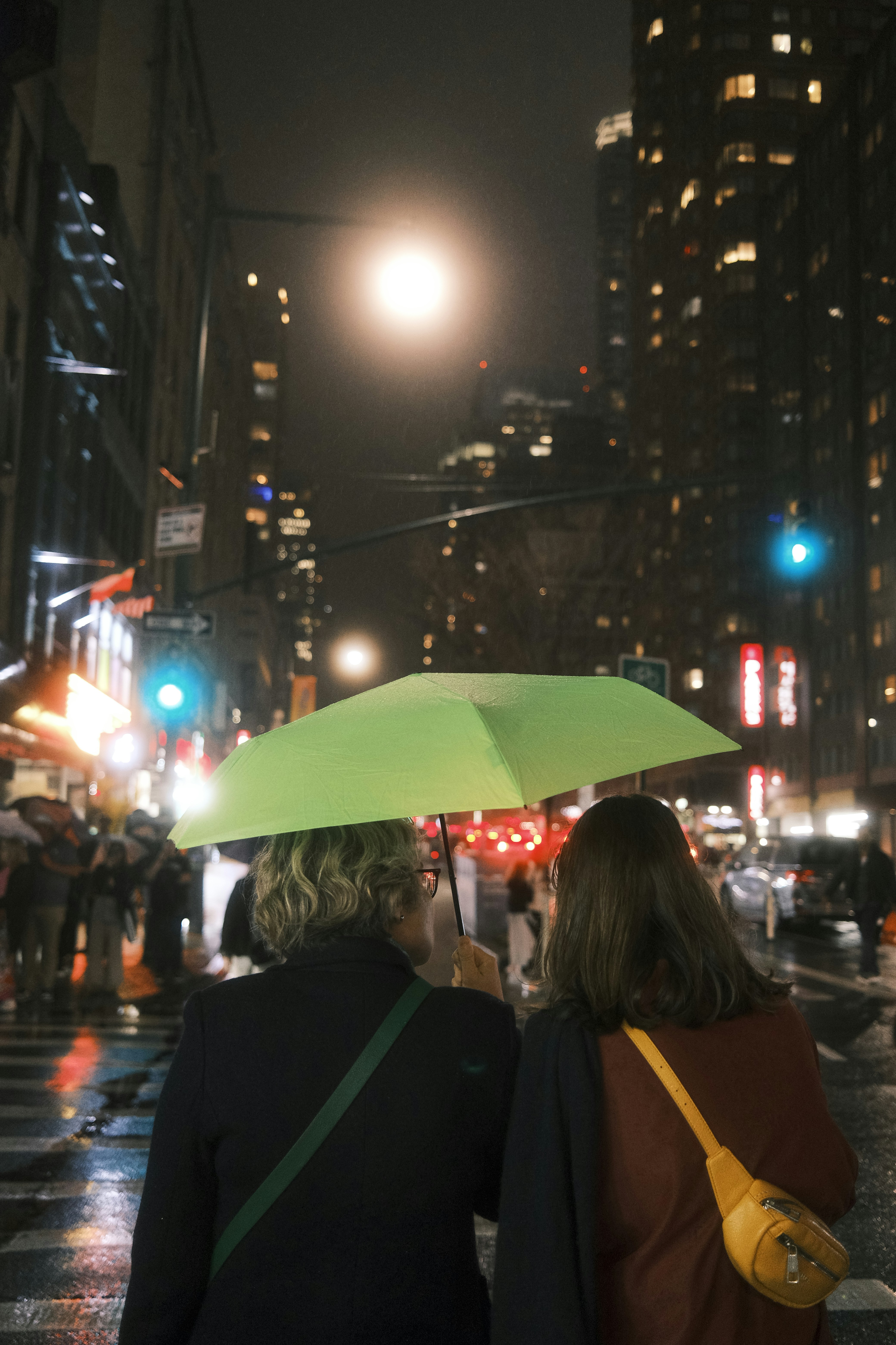 a couple of people that are standing under an umbrella