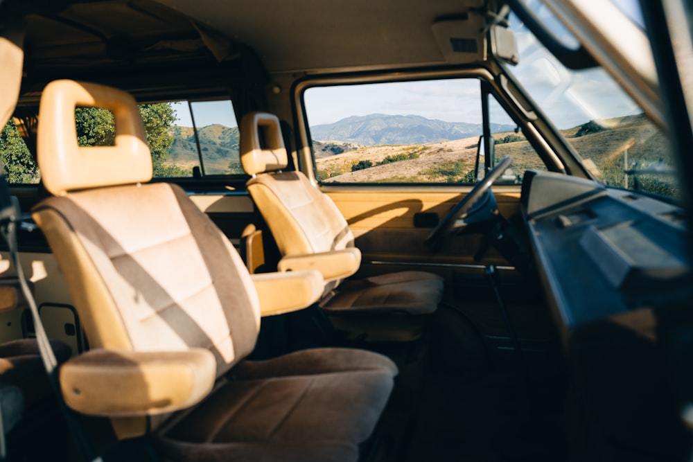 the interior of a vehicle with a view of mountains