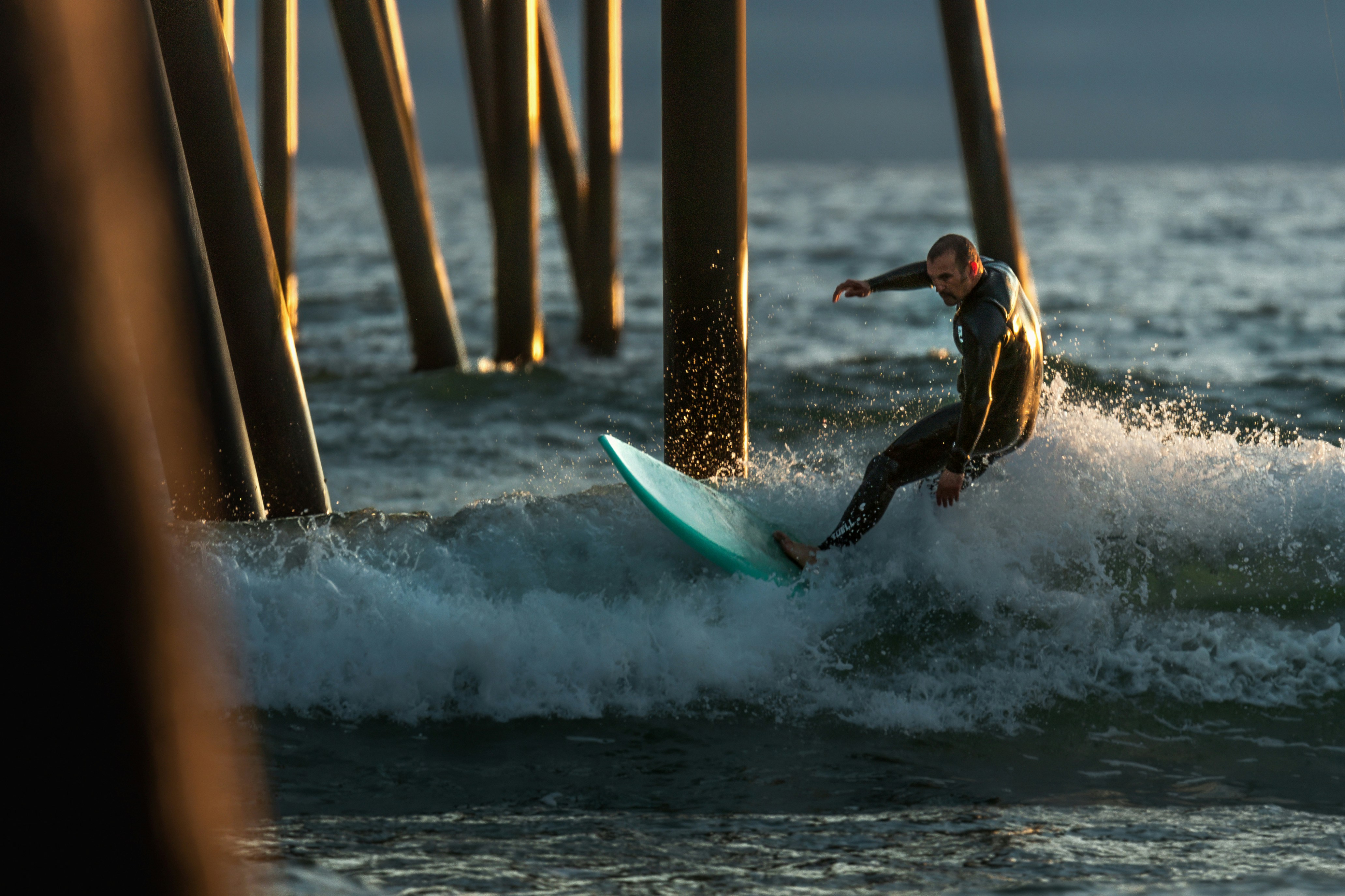 a man riding a wave on top of a surfboard