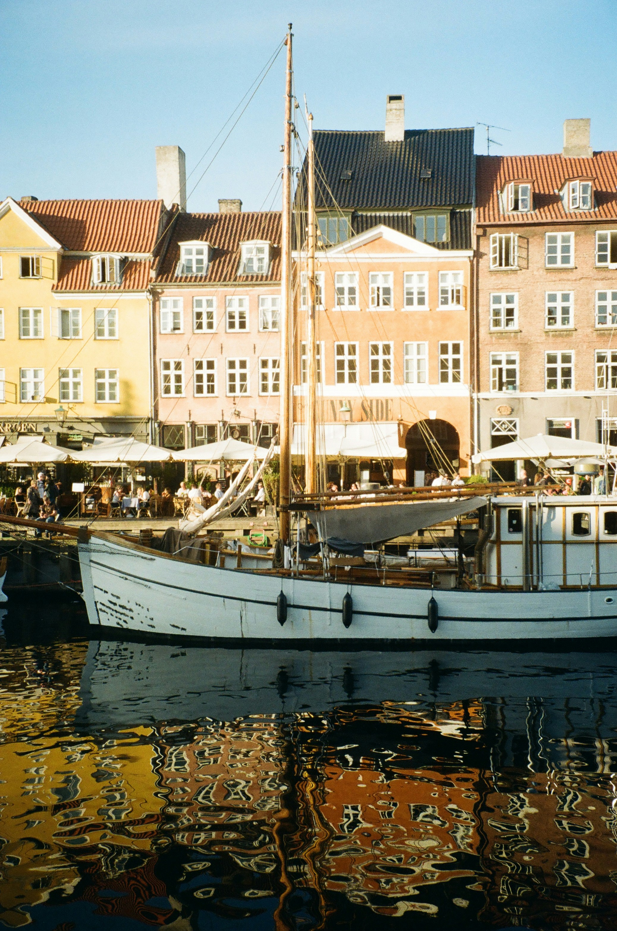 a white boat floating on top of a body of water