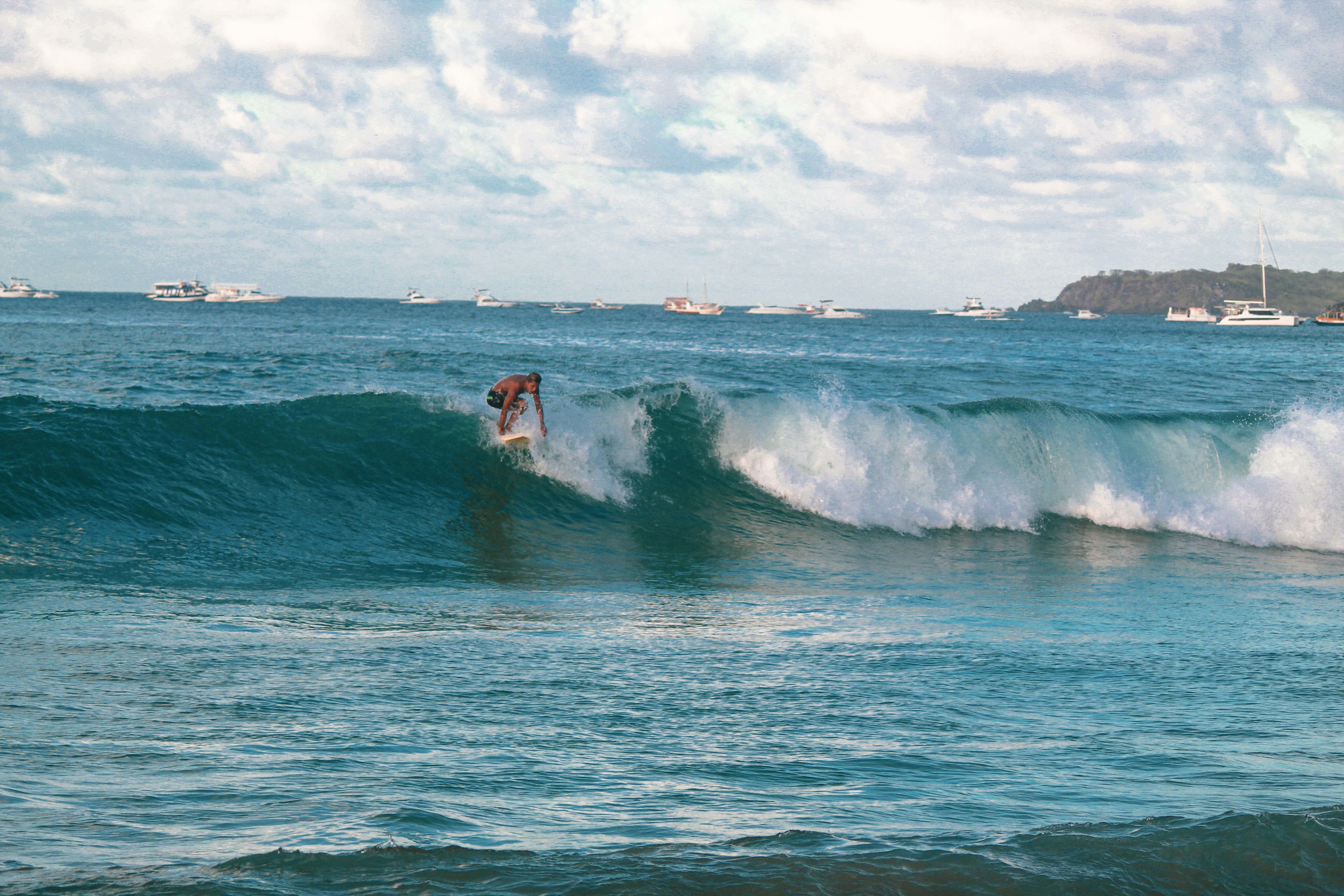 a man riding a wave on top of a surfboard