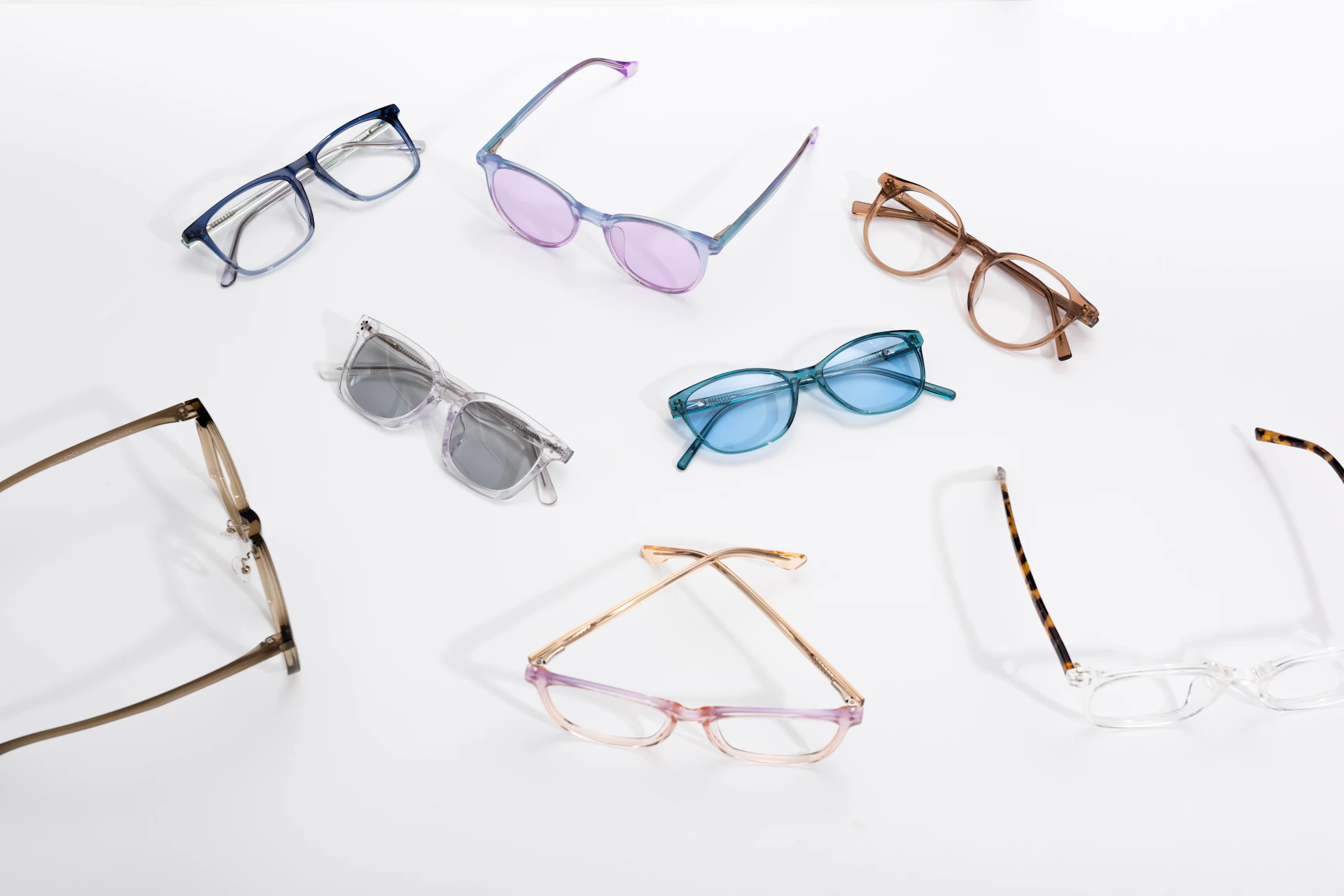 six pairs of glasses sitting on top of a white surface