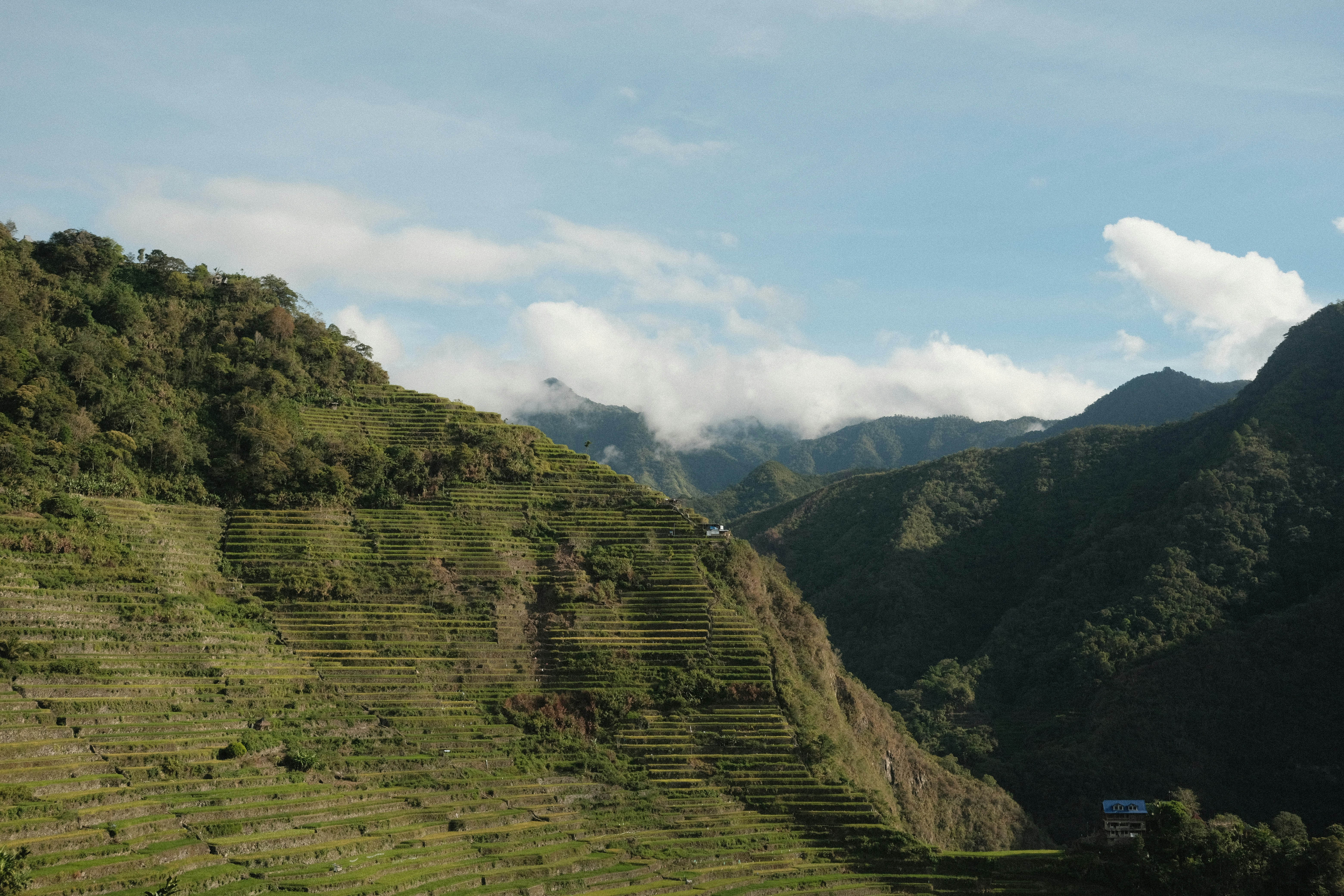 a view of a mountain range with a house on the top