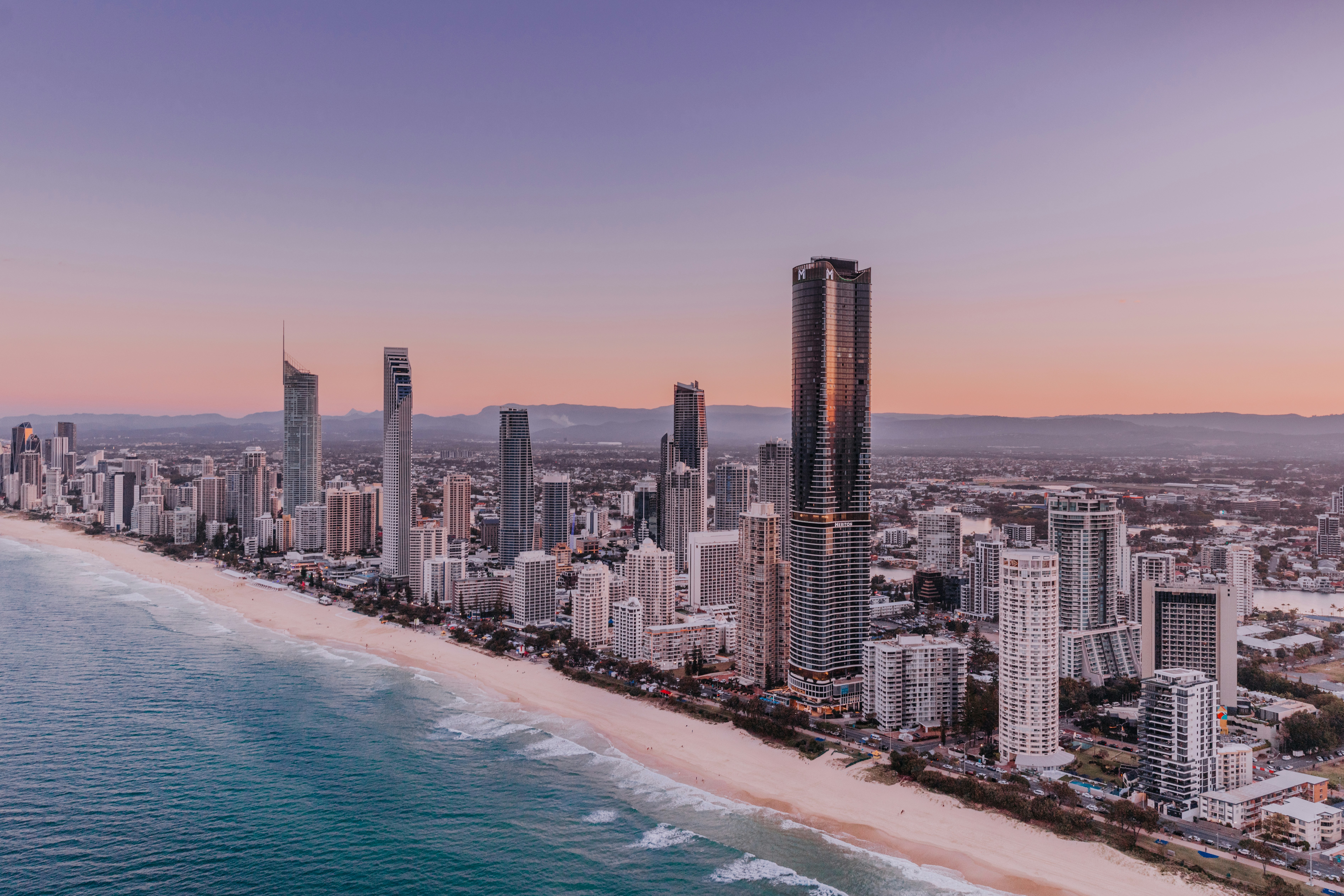 an aerial view of a city and the ocean