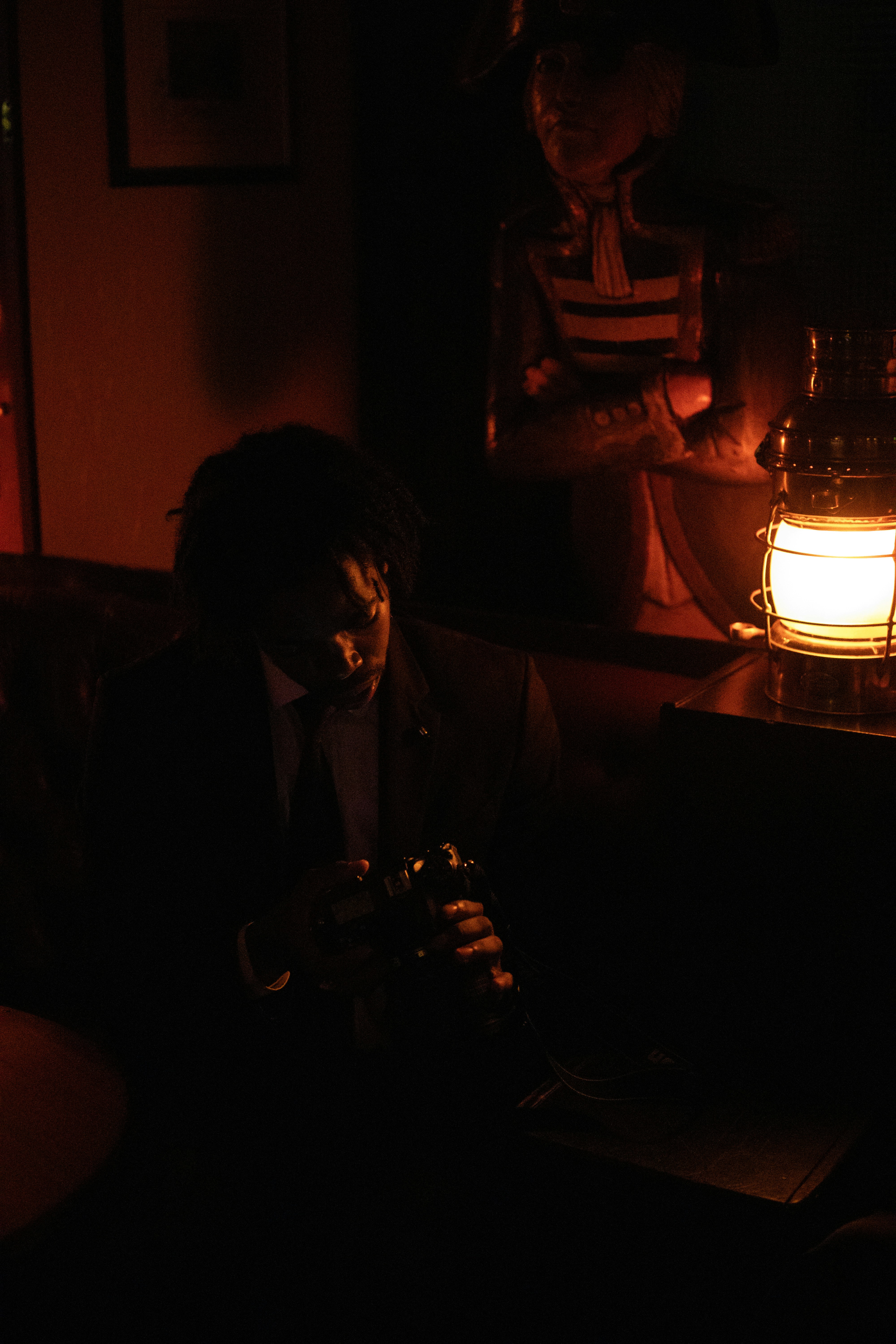 a man in a dark room looking at his cell phone